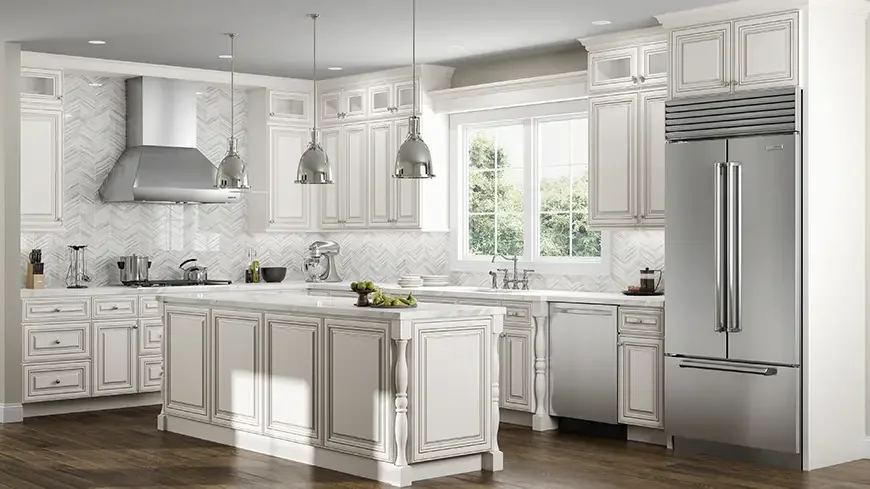 Bright white kitchen with white cabinets, island, stainless steel appliances, and large window with greenery outside.