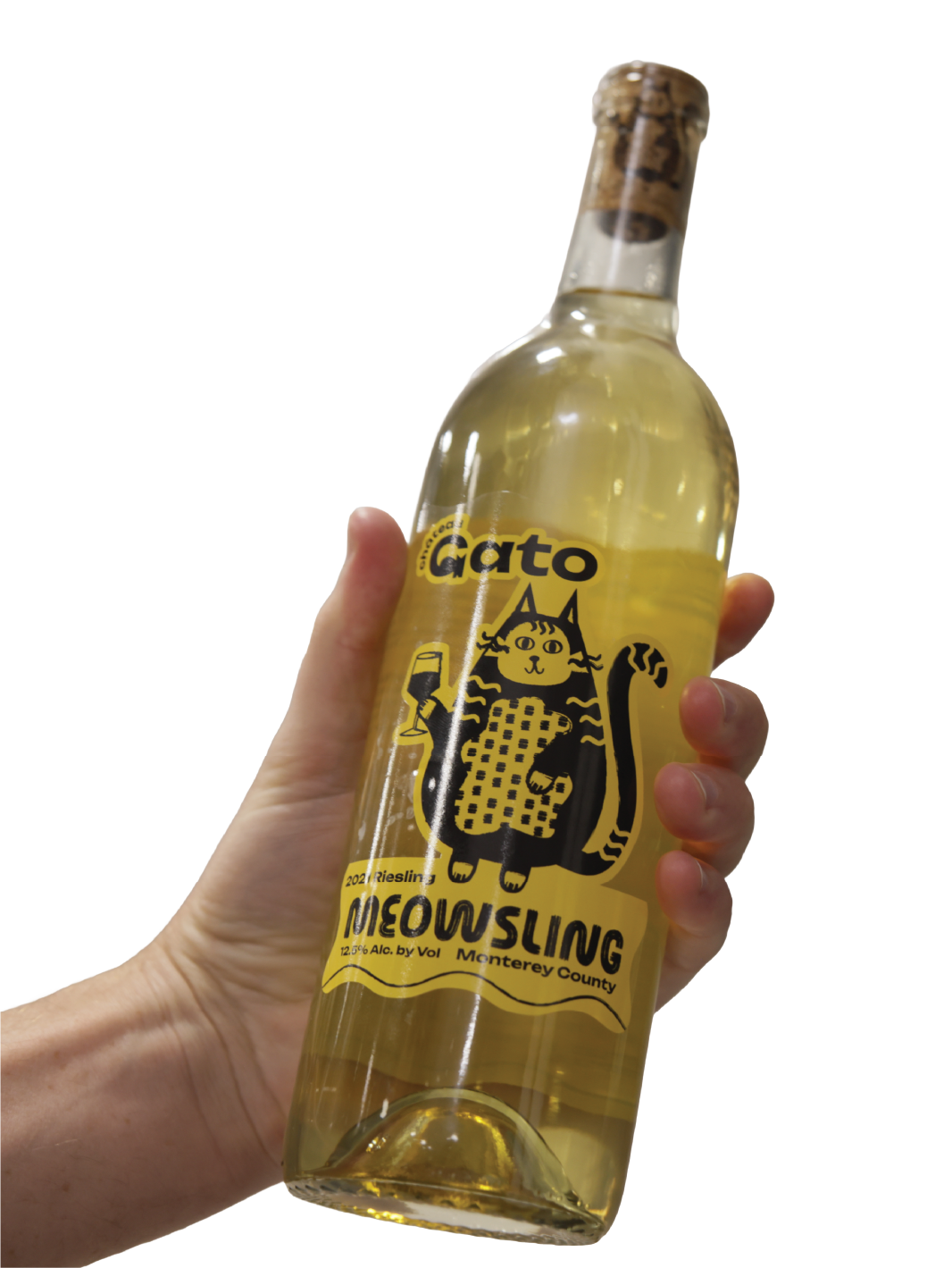 A hand holding a bottle of white wine with a label featuring a cartoon cat holding a glass of wine and a cheese platter, with the text "Gato Meowsling 2021 Riesling Monterey County 12.5% Alc."