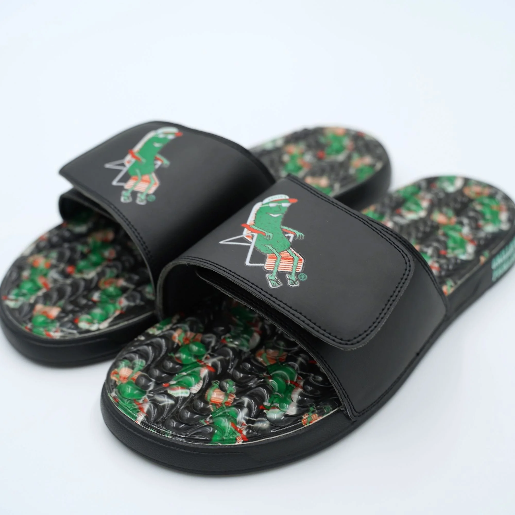 Black pool slides with a pickle printed on the top and a pickle pattern printed on the insole. 