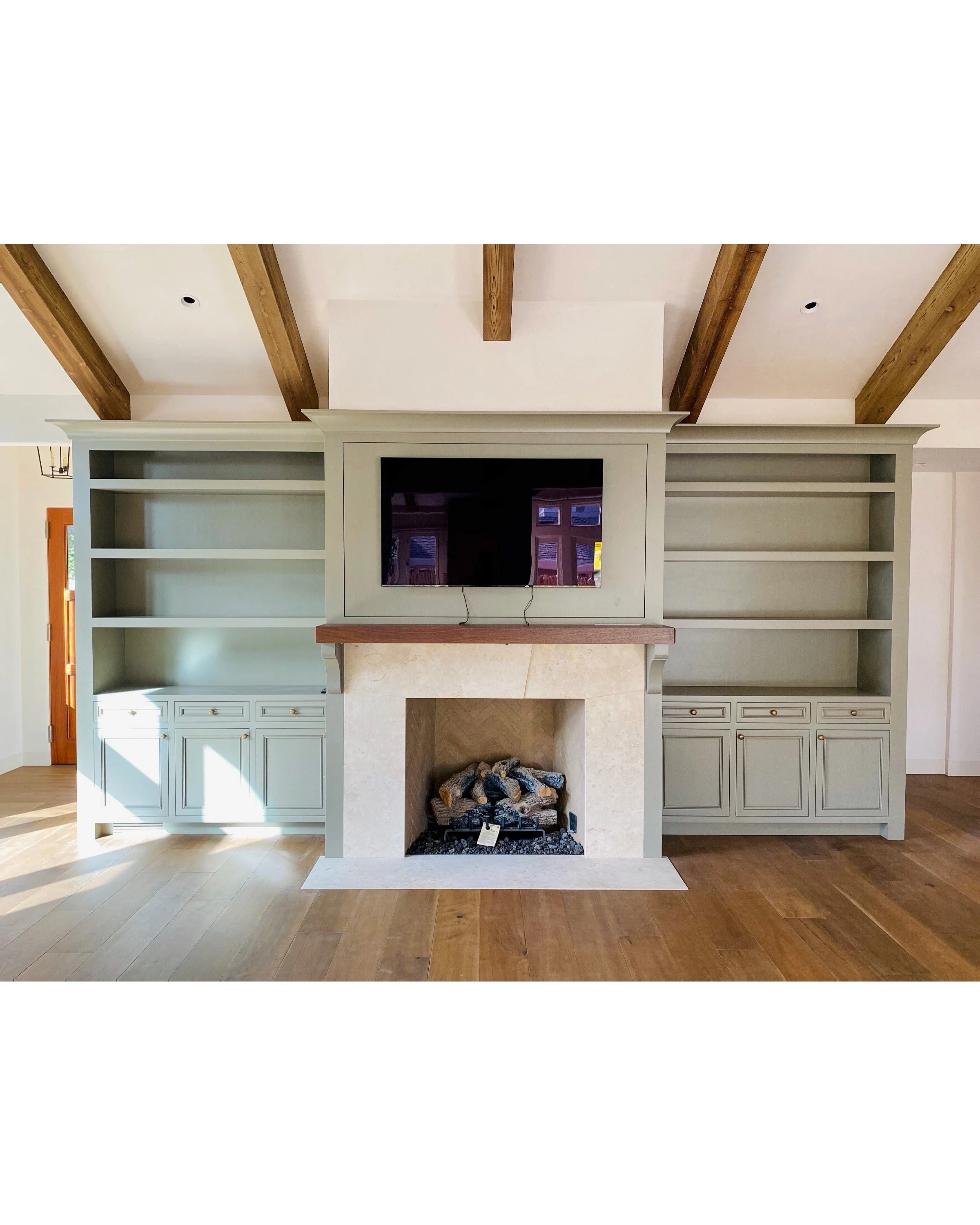 Custom built-in buffets in a living room with custom box beams on the ceiling in Monterey California