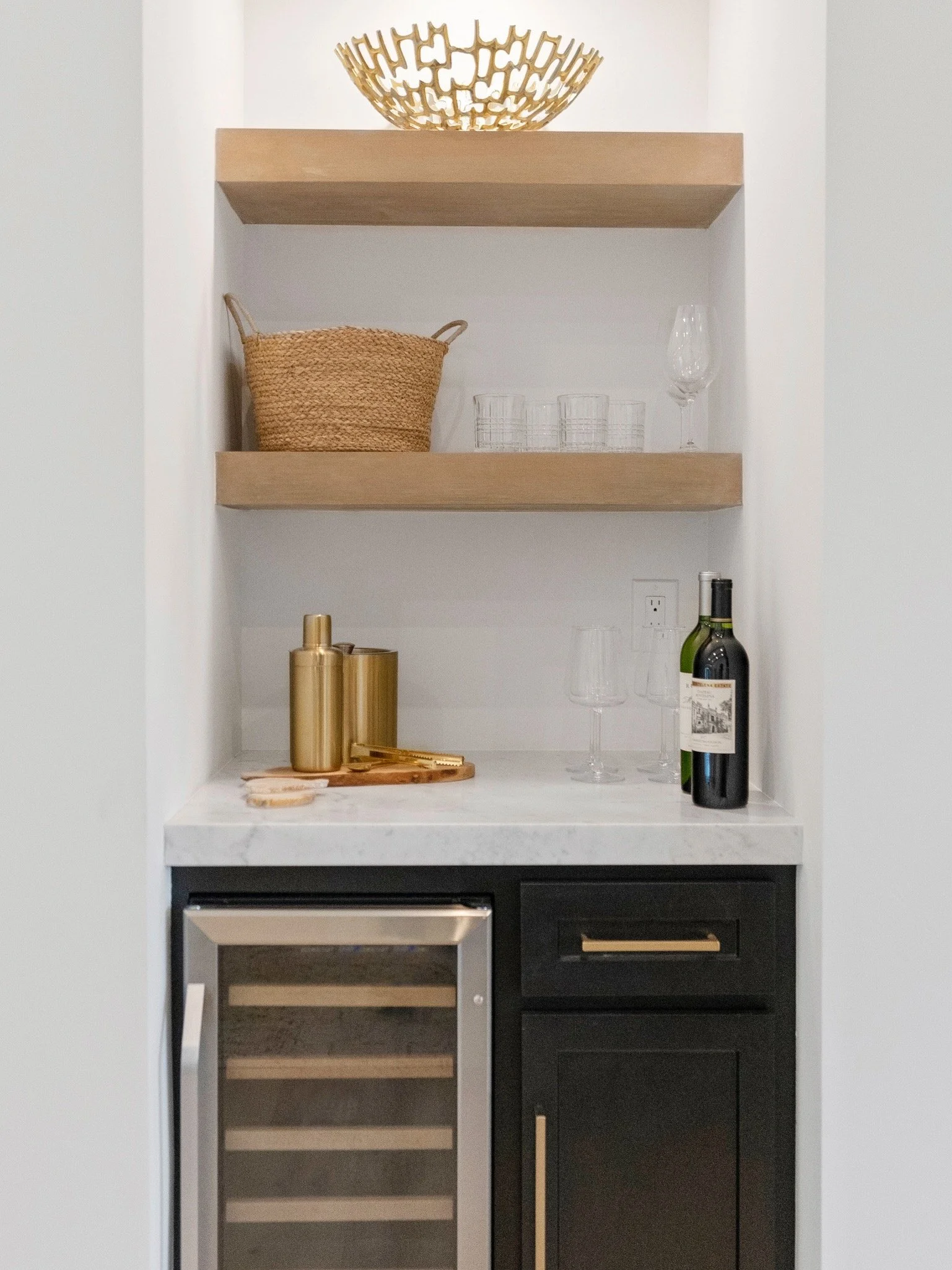 Custom woodwork above a wine refrigerator completed by Valley Mill Shop in Monterey California
