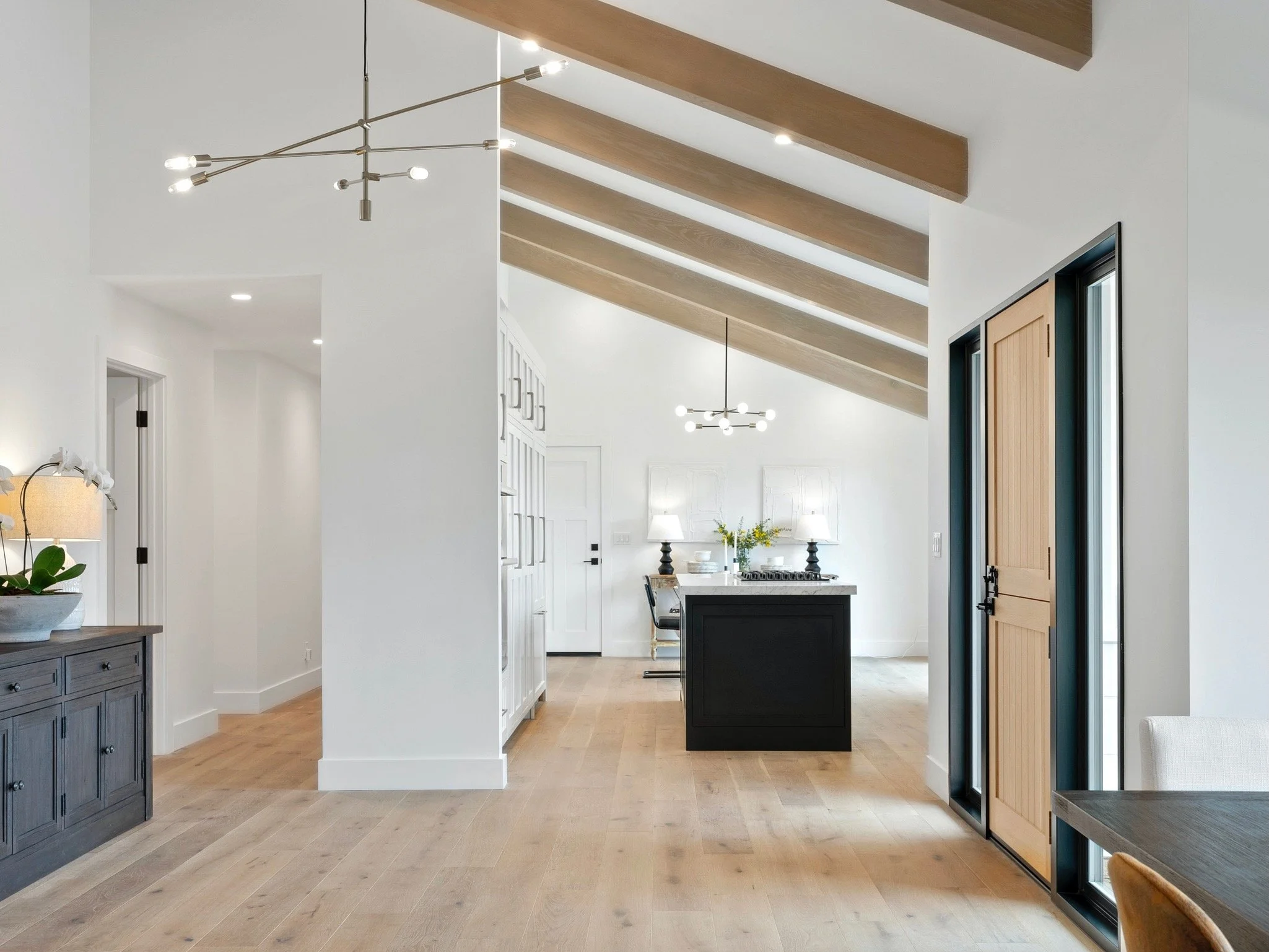 A kitchen layout with custom cabinets in white that were designed by Valley Mill Shop