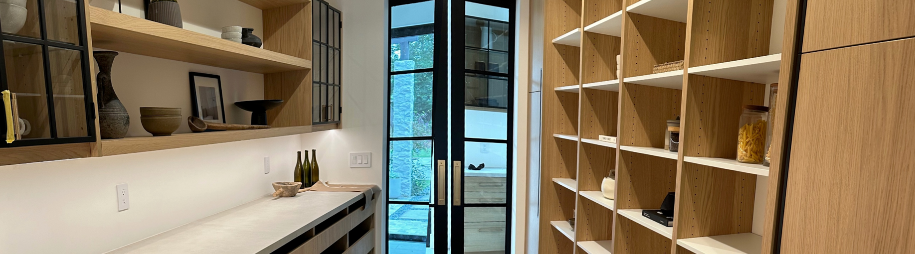 A custom walk-in closet in carmel California with shelf features on the left and individual closet cubbies on the right.