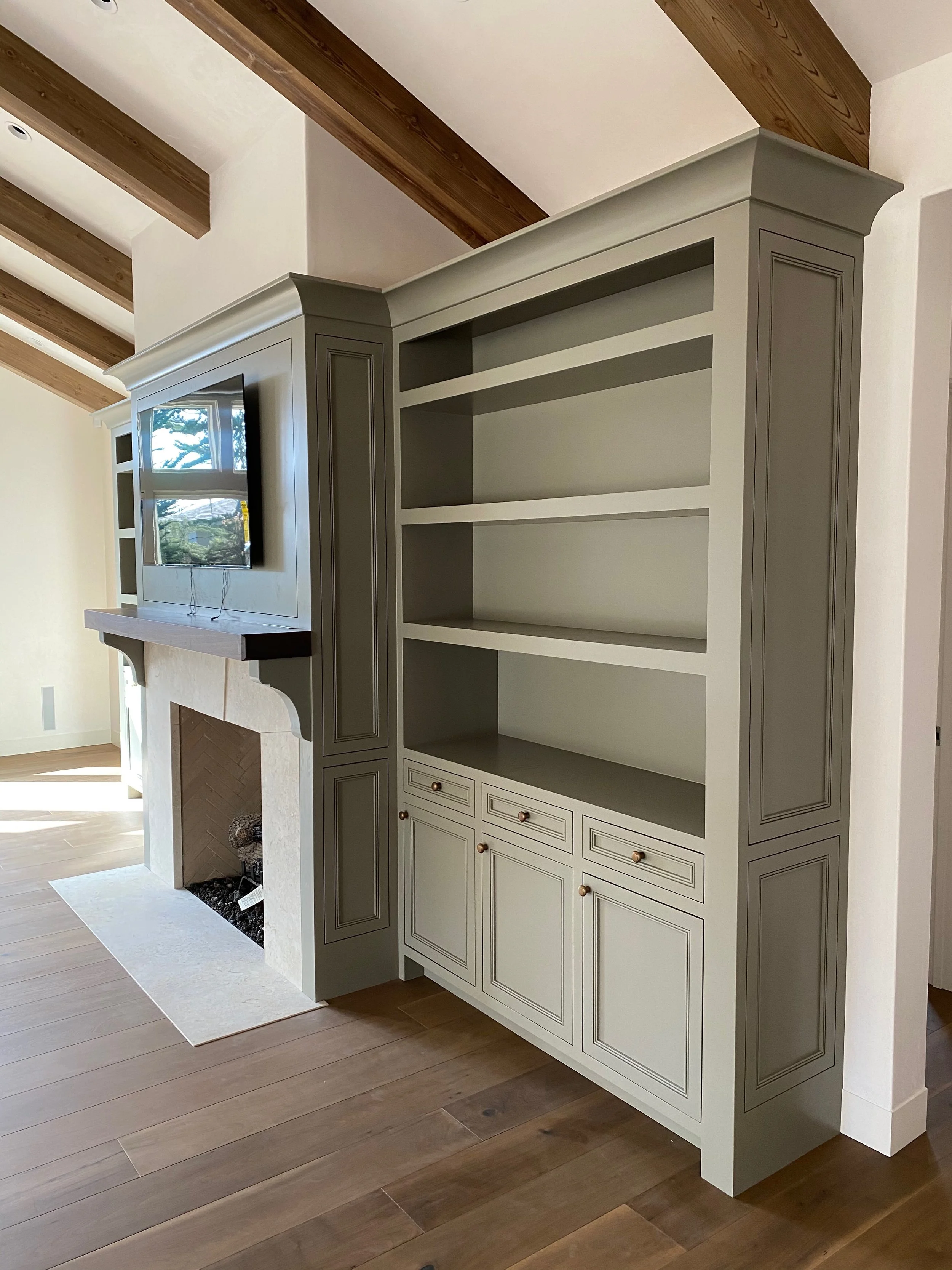 Custom built-in buffet shelving around a fireplace in Monterey California