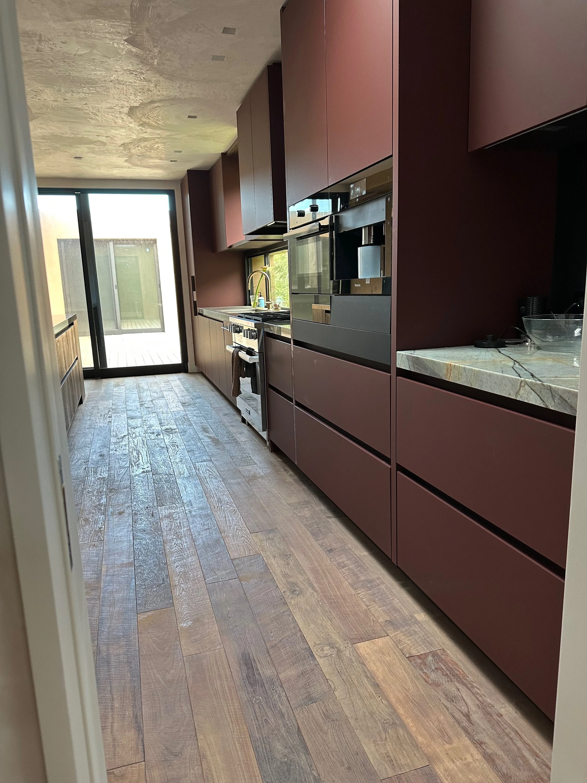 Custom walk-in closet with beautiful reclaimed wood flooring in a house in Monterey California