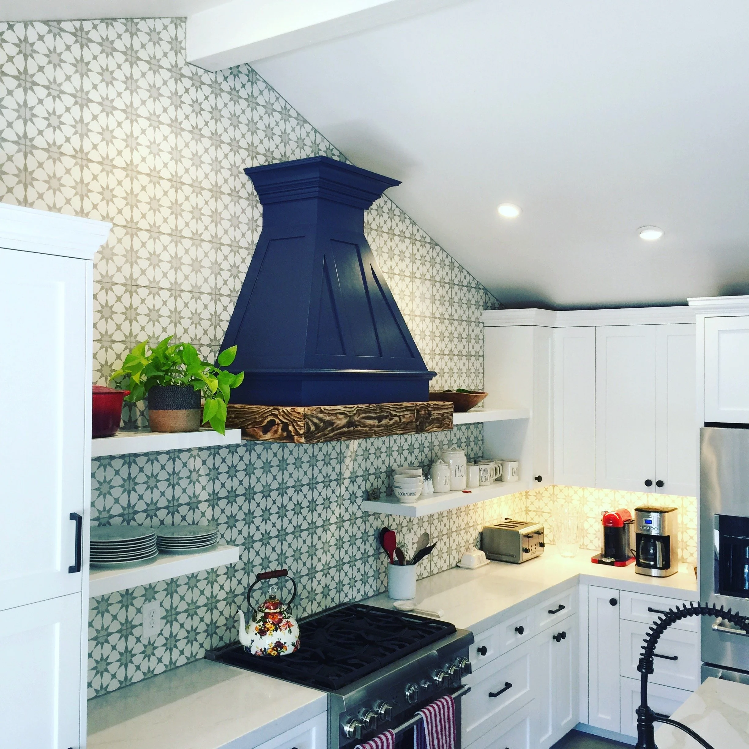Custom woodwork and shelves around a kitchen hood in Carmel-by-the-sea