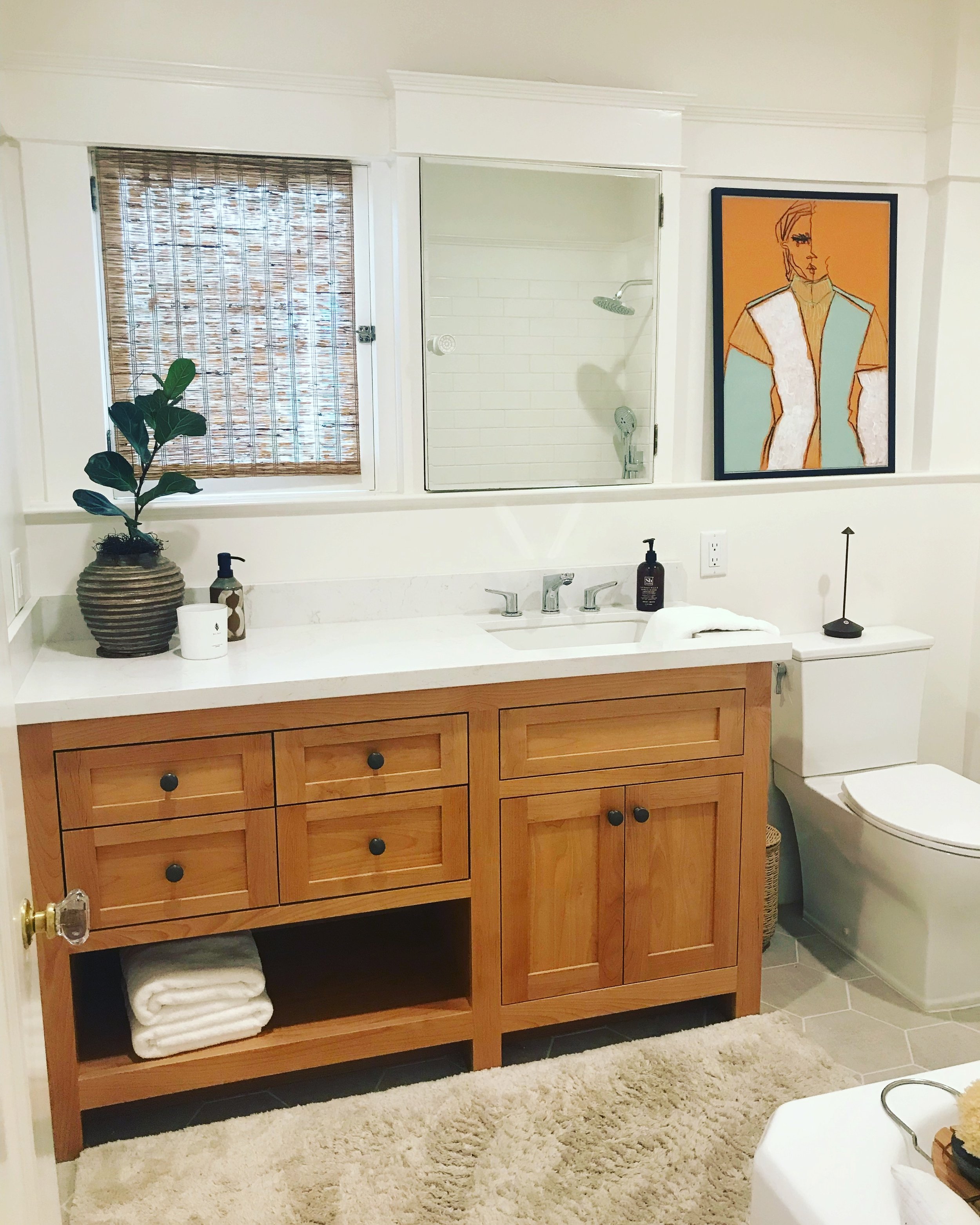 Custom bathroom vanity with natural wood tones and a marble countertop and sink