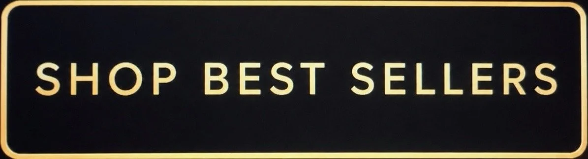 Black sign with beige border and text that reads "SHOP BEST SELLERS"