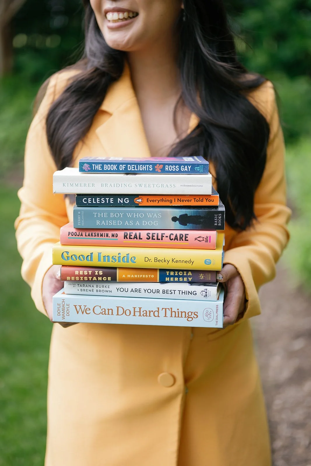 Stack of therapy books held by therapist