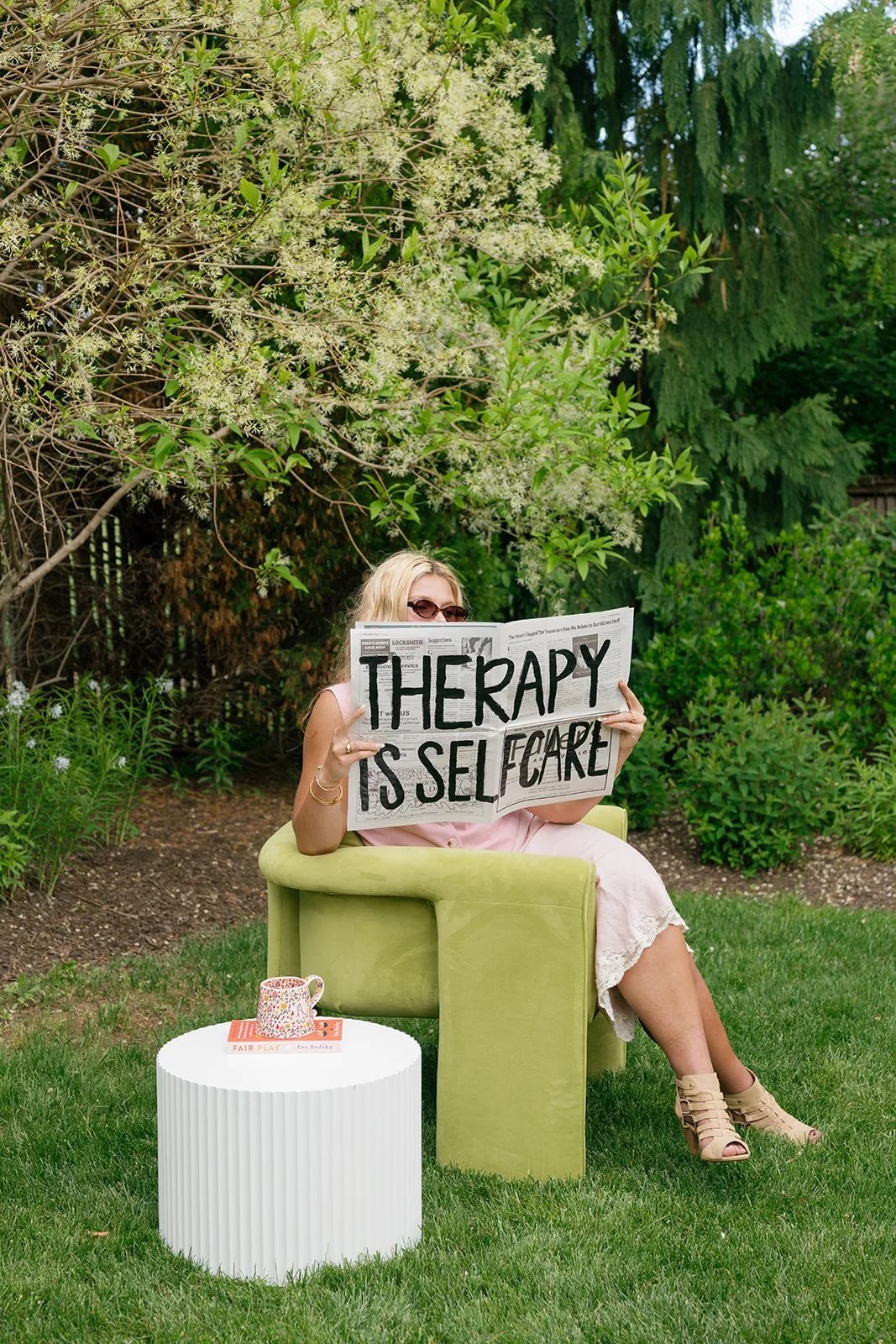 Marigold Therapist reading newspaper, "therapy is self care"