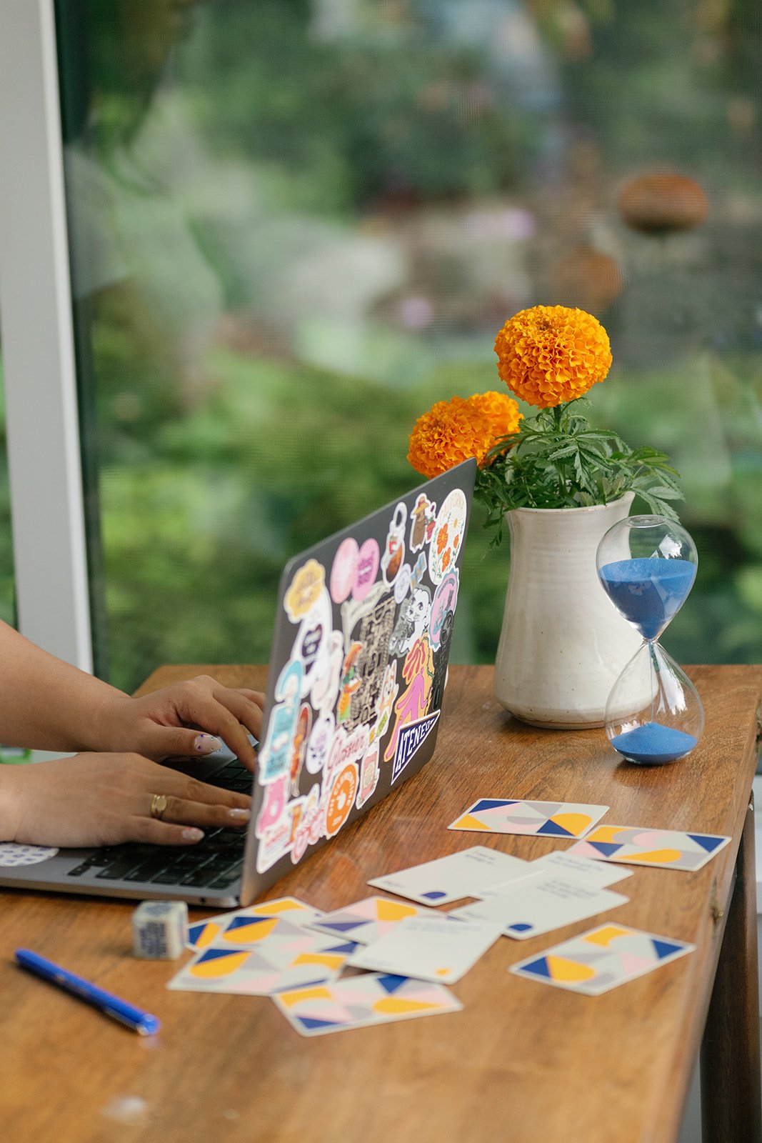 Therapist on laptop with marigold flowers