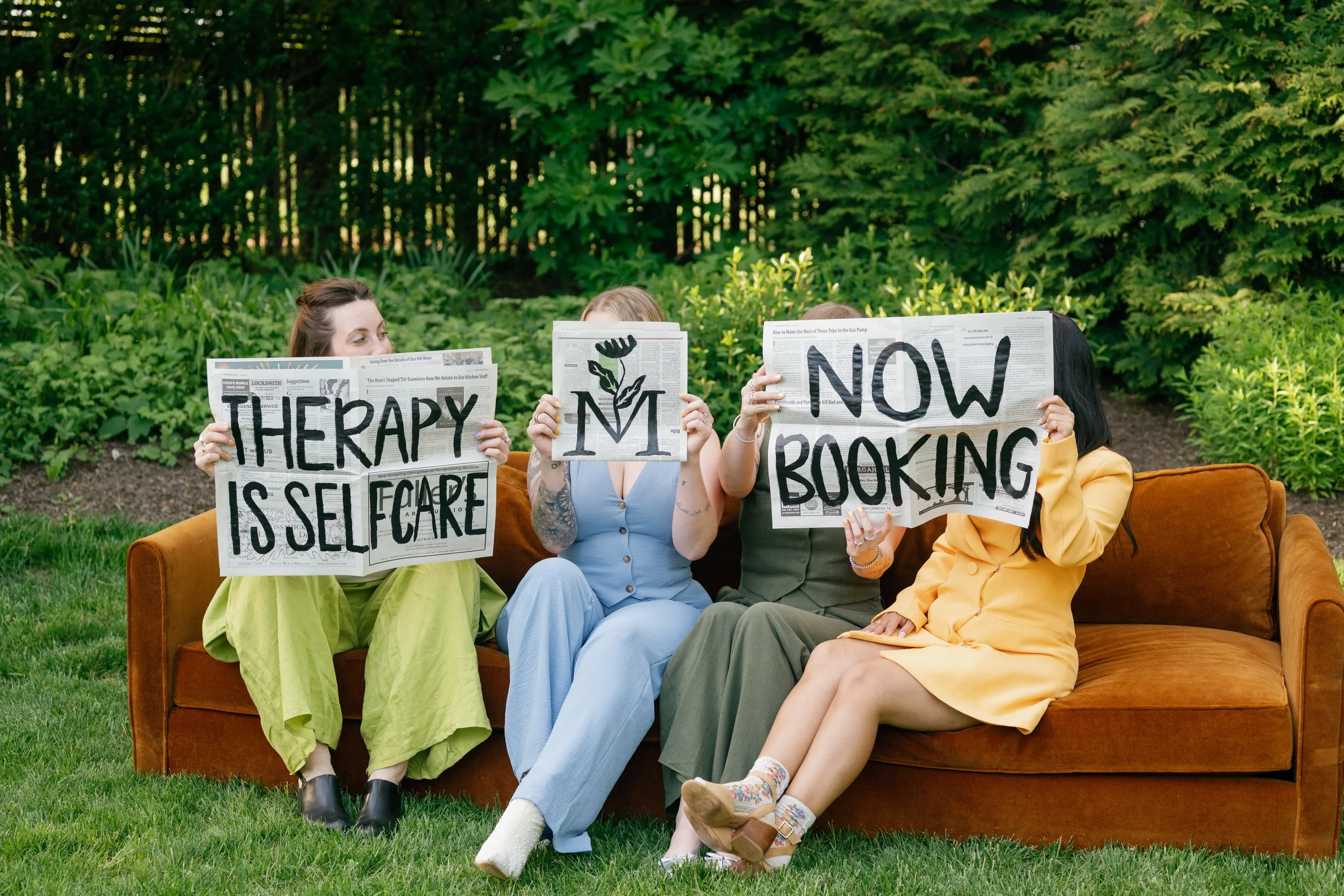 Therapists behind newspapers
