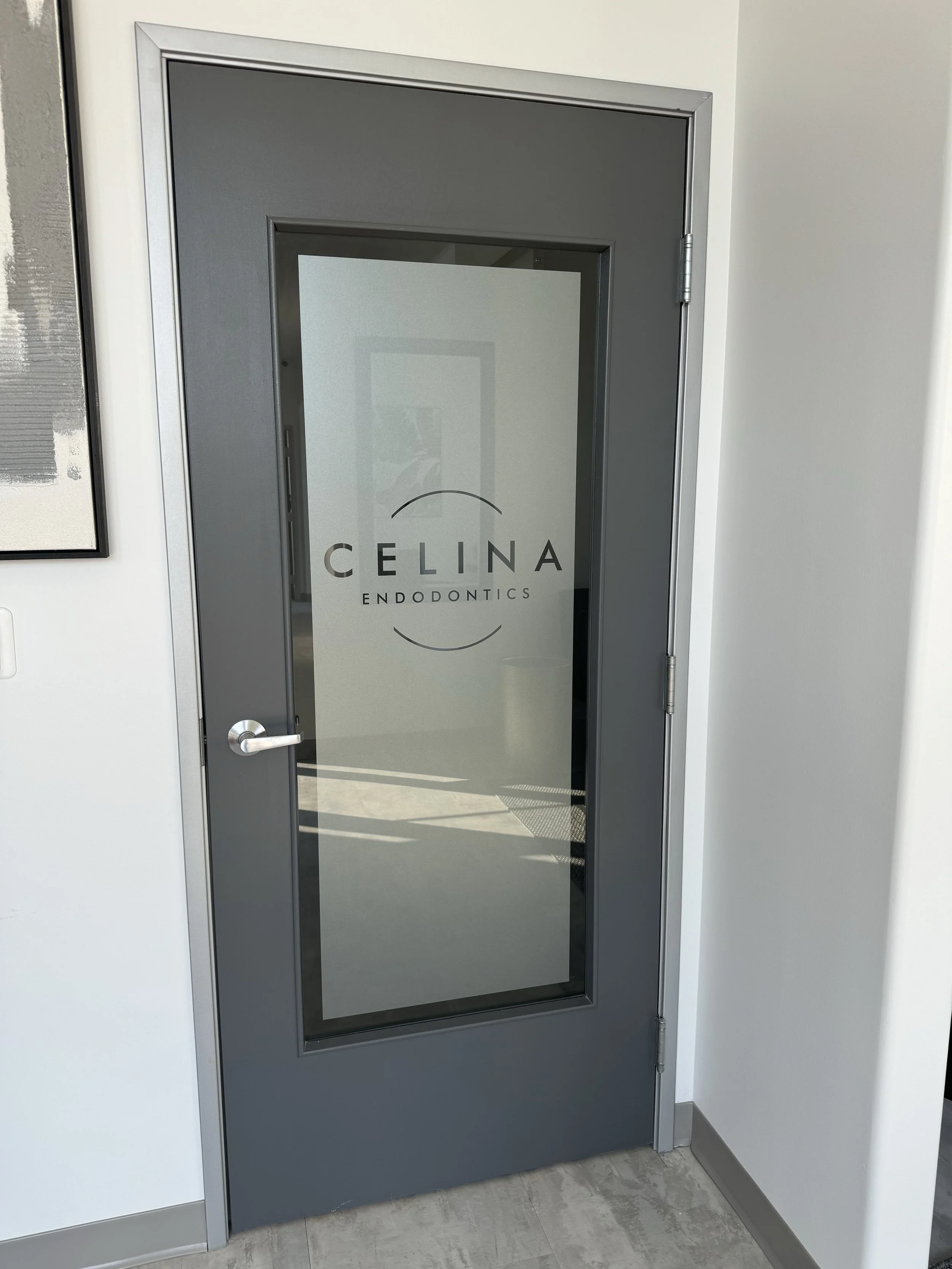 Glass door with the logo 'CELINA ENDODONTICS' on it, frosted vinyl, perfectly installed indoor