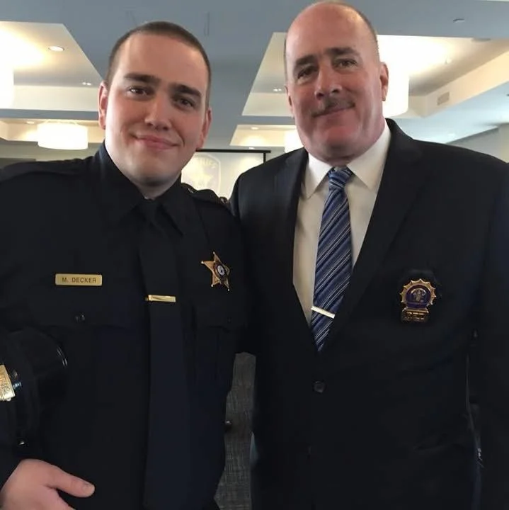 Mike joining the Sheriff's Office, photographed with his father.