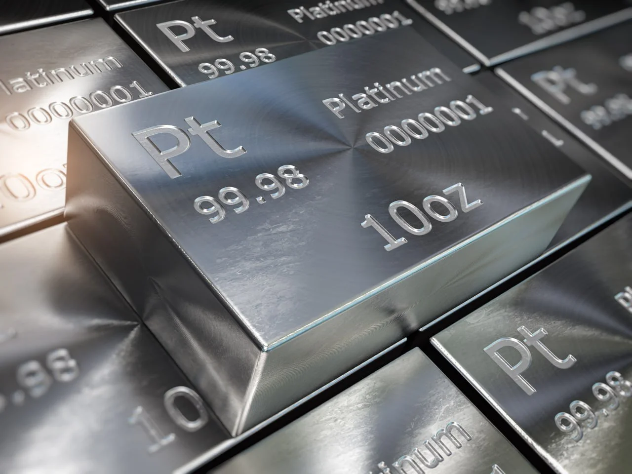 Close-up photo of a shiny silver platinum bar with the weight of 100 ounces and price of $99.98 per ounce, displayed among other metal bars.