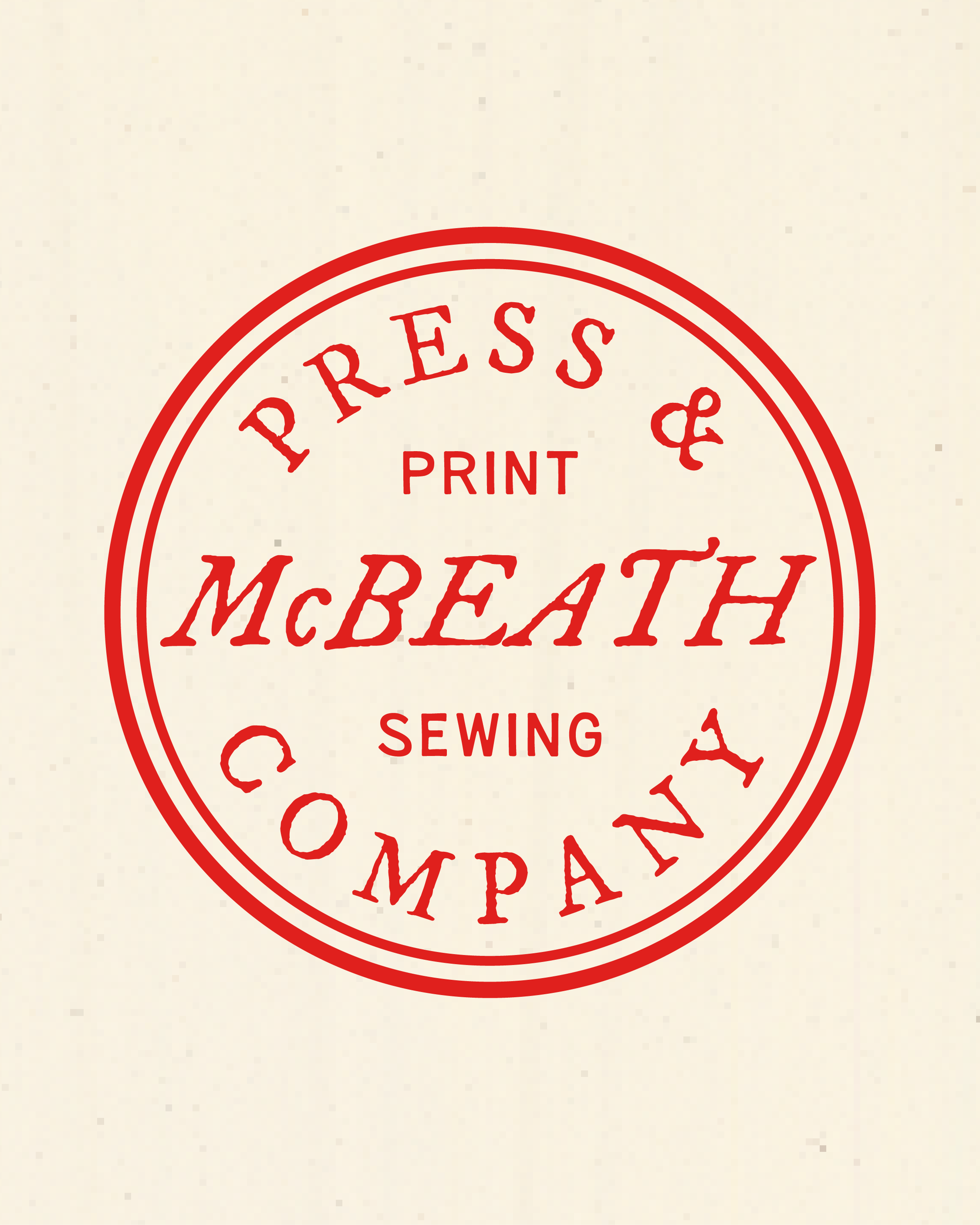 Close-up of a vintage-style red stamp with the words 'Press & Print' and 'McBeath' on a cream-colored paper background.