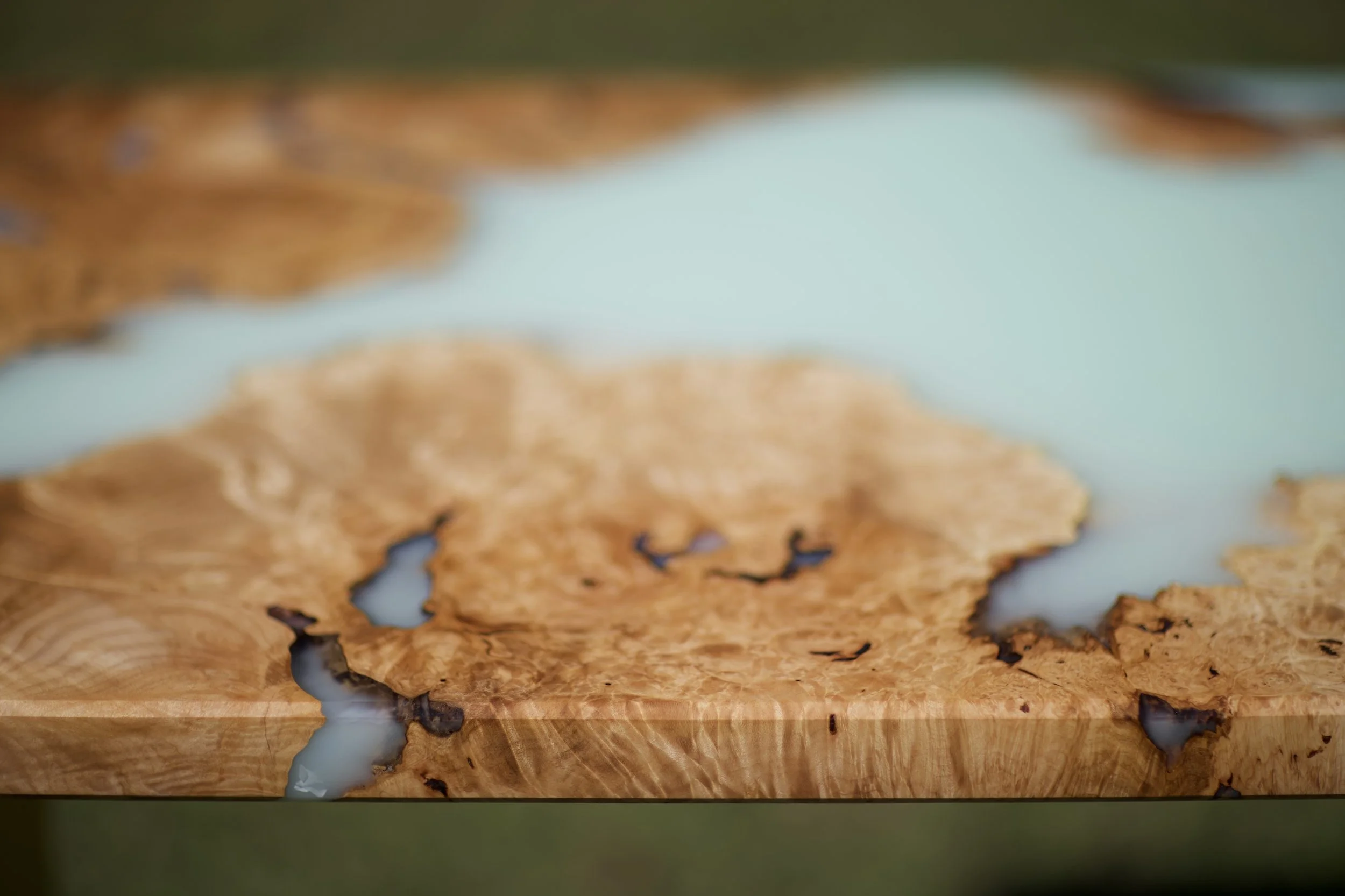 Close-up of a maple burl desk with resin