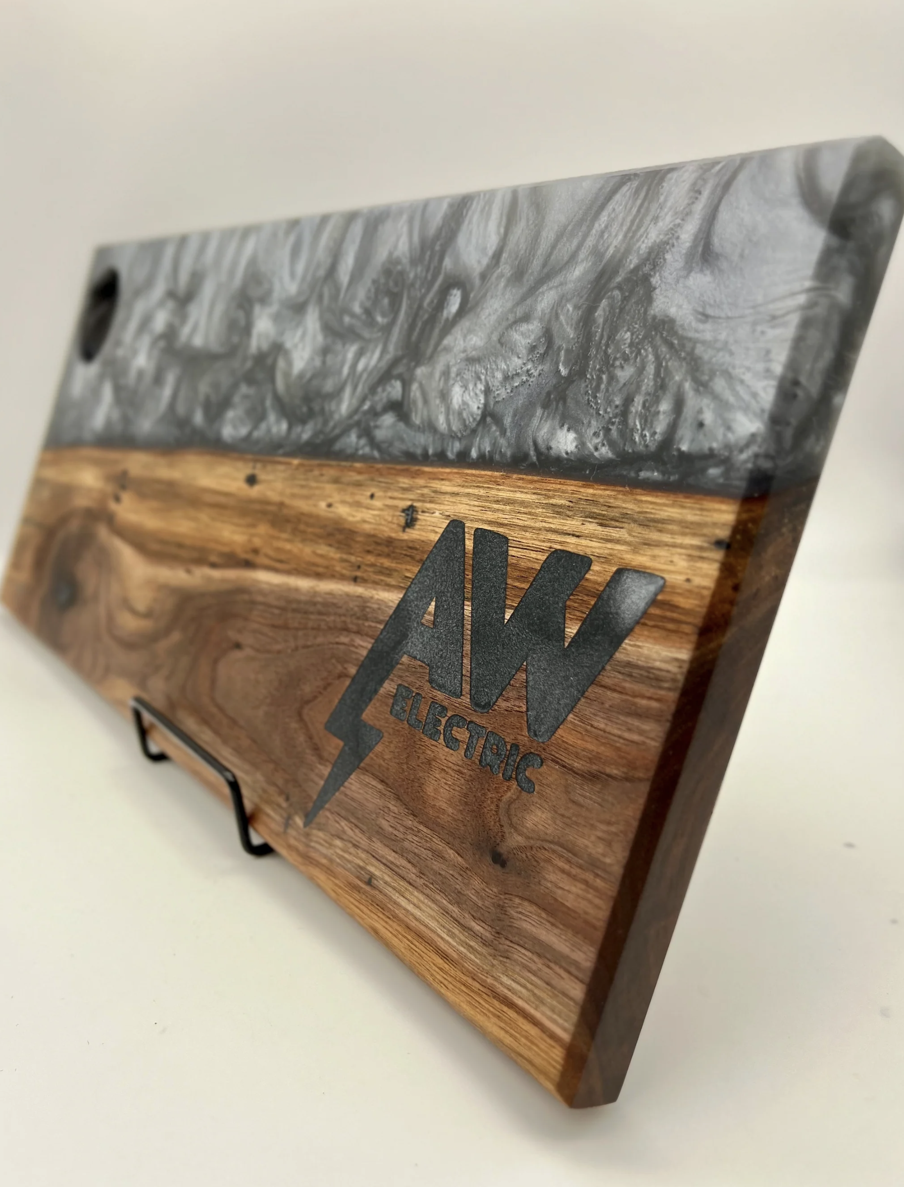 Wooden box with a metal top and a lightning bolt logo with the text 'AKW Electric' underneath.