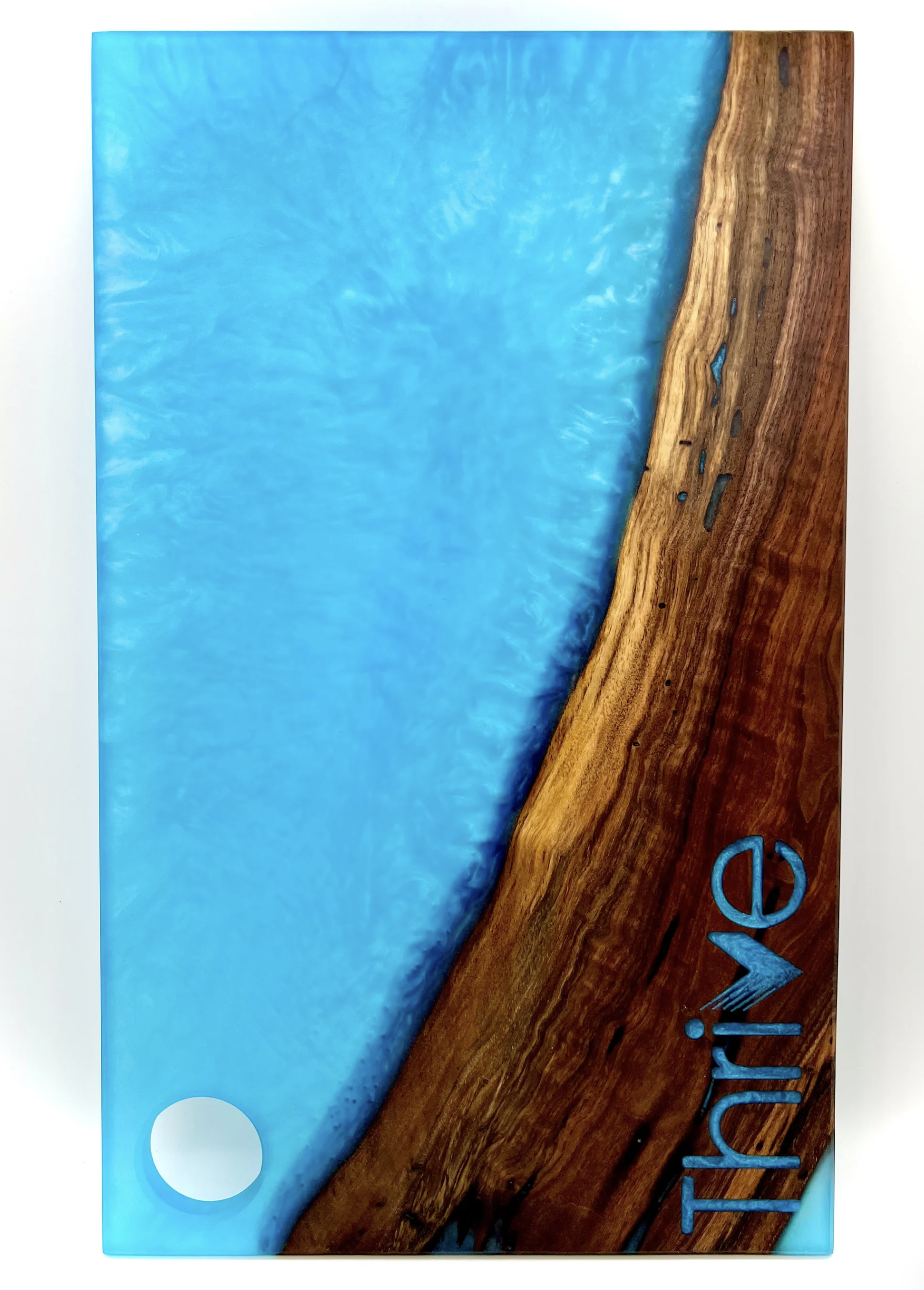 Close-up of a wooden surface with blue and turquoise painted elements, and partially visible text that appears to spell "Vive."