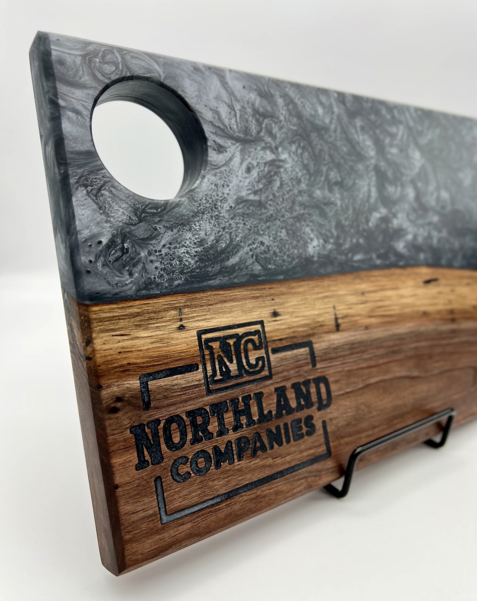 Wooden box with a textured gray metal top and black printed text reading 'Northland Industries'.