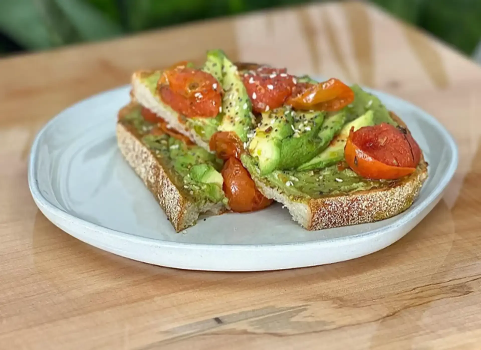 Healthy avocado toast with confit tomatoes and everything seasoning served at Green Goods Café in Providence RI