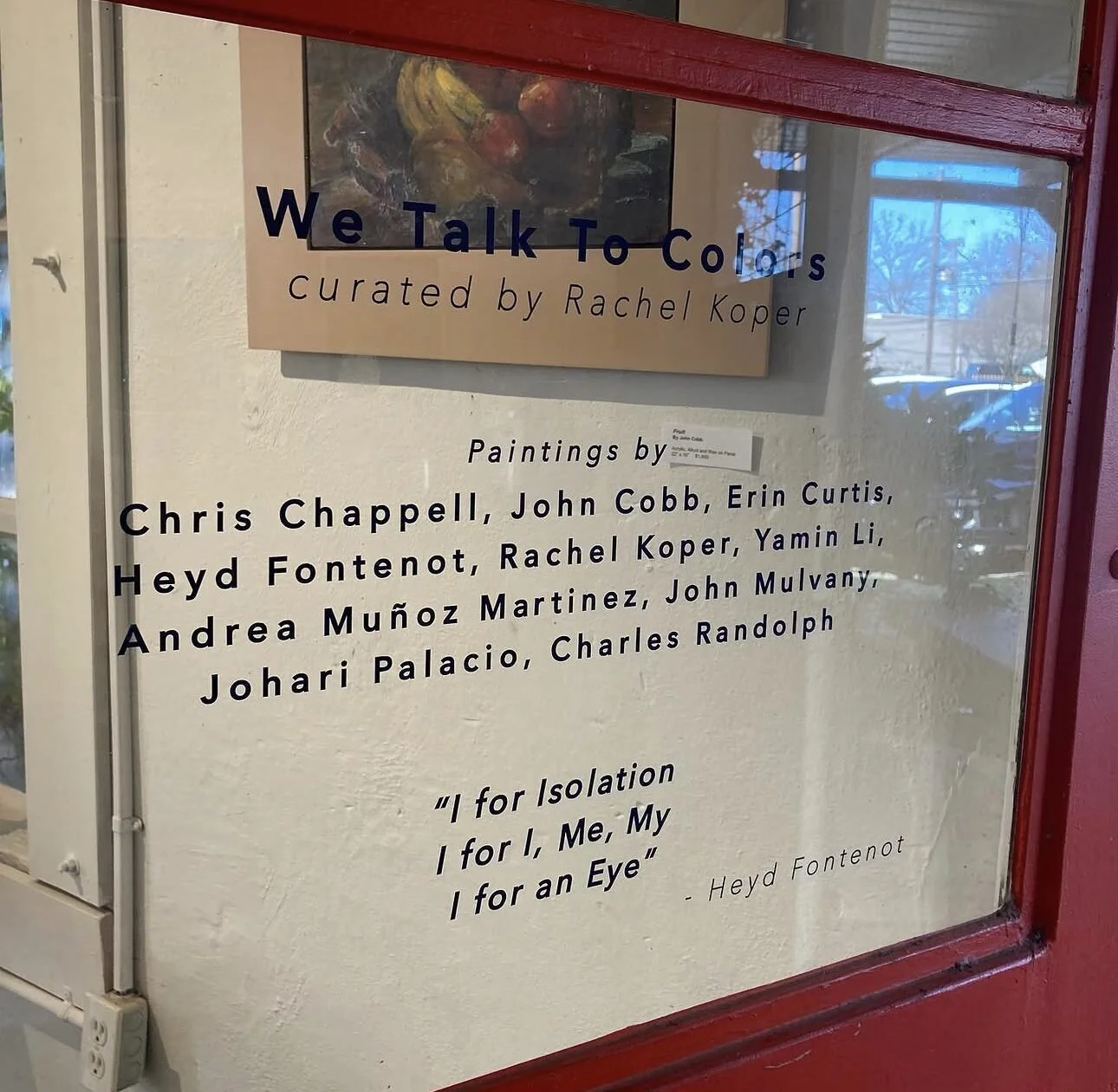 Sign for art exhibition titled 'We Talk To Colors,' curated by Rachel Koper, featuring paintings by various artists including Chris Chappell, John Cobb, Erin Curtis, Heyd Fontenot, Rachel Koper, Yamin Li, Andrea Muñoz Martinez, John Mulvany, Johari Palacio, and Charles Randolph. Includes a quote by Heyd Fontenot about isolation.