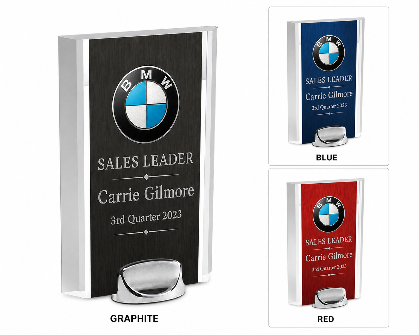 A set of three BMW sales leader trophies in graphite, blue, and red colors, each featuring a large BMW logo at the top, with customized text for Carrie Gilmore, 3rd quarter 2023, and a metallic base.