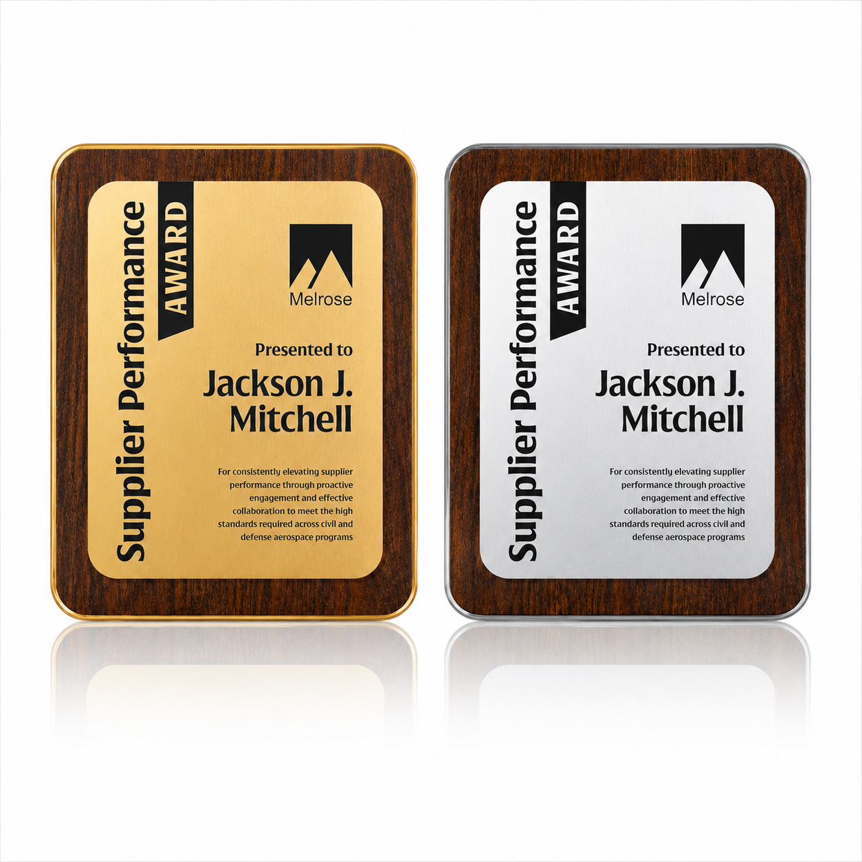 Two award plaques with a wood border, one gold and one silver, both titled 'Supplier Performance AWARD' and presented to Jackson J. Mitchell by Melrose, with a description of their supplier performance.