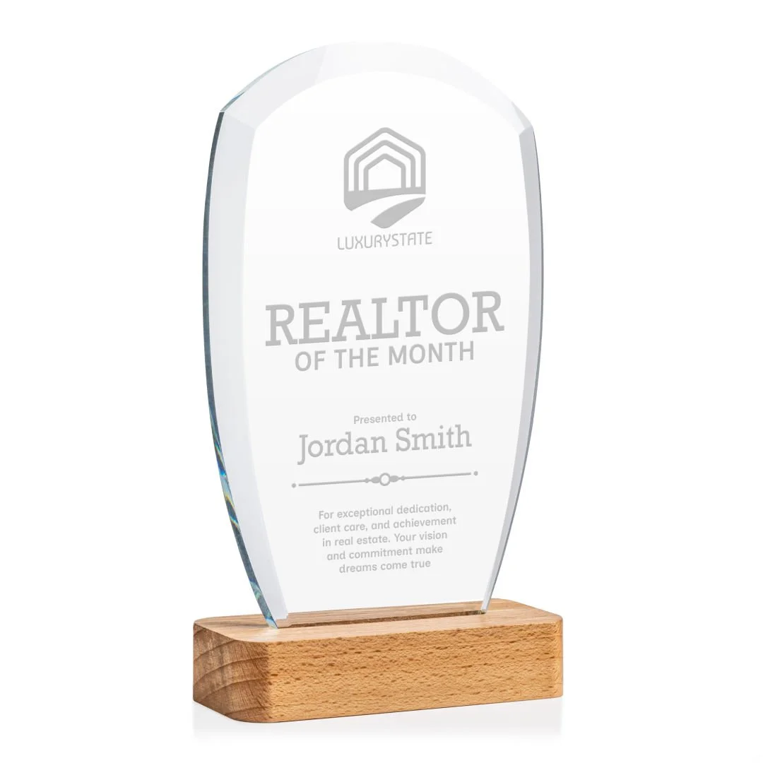 Clear glass award with wooden base engraved with 'Realtor of the Month' presented to Jordan Smith by LuxuryEstate.
