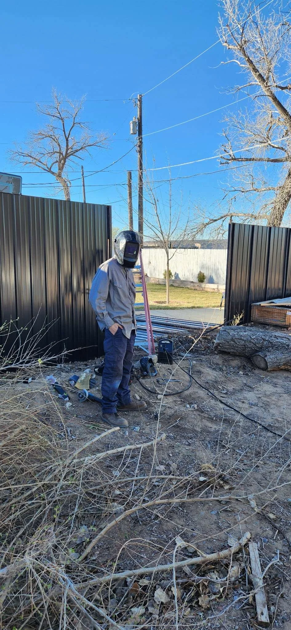 A welder repairing a fence