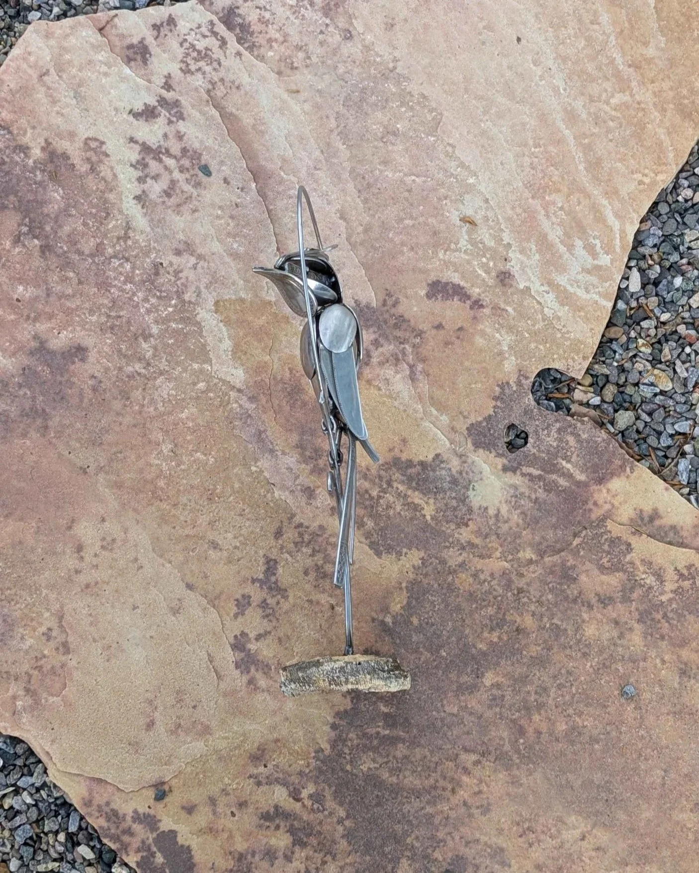 de from silverware attached to a petrified wood base.