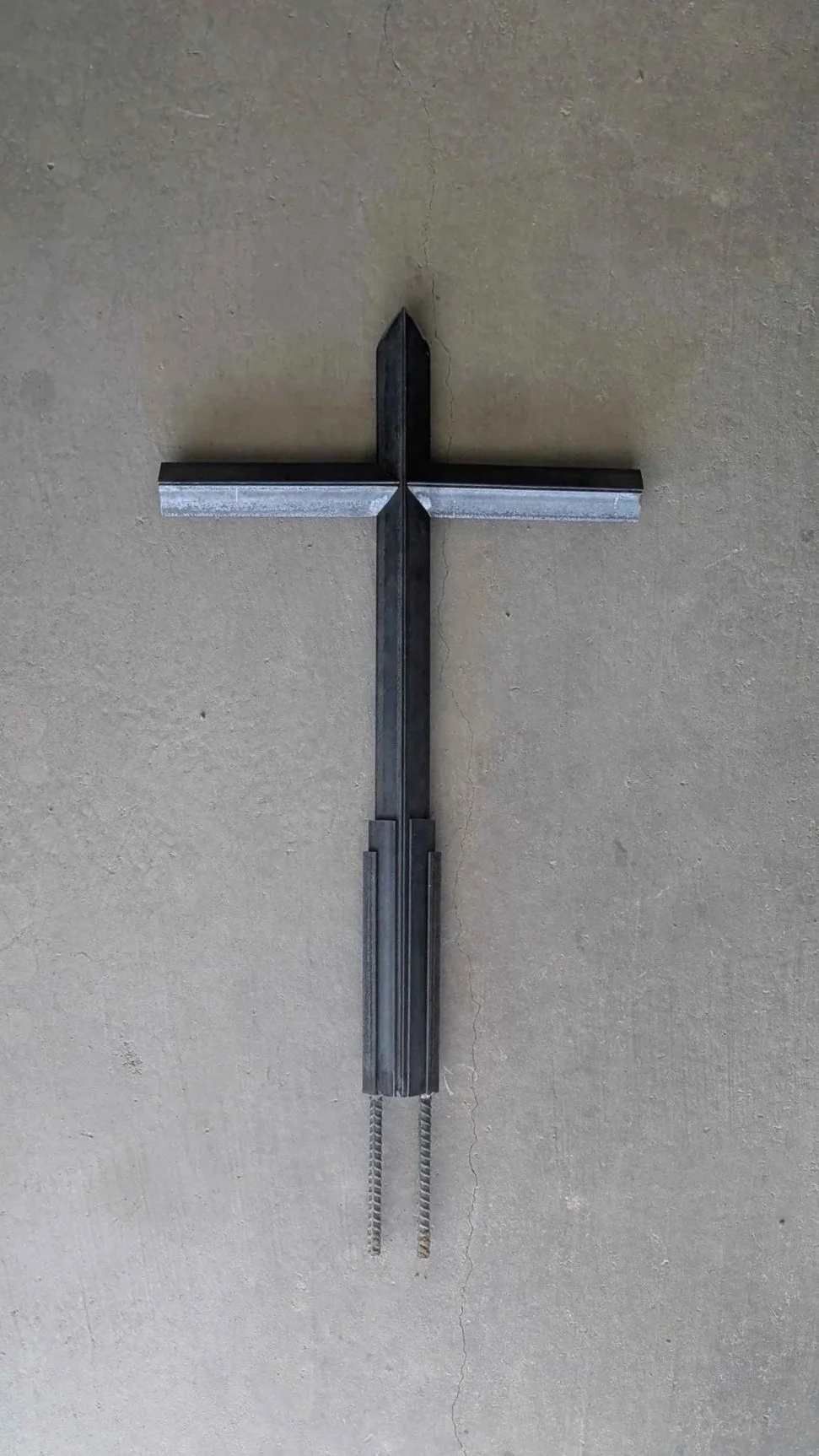 A large metal art cross sculpture made from carefully layered angle iron, designed to be a yard decoration.