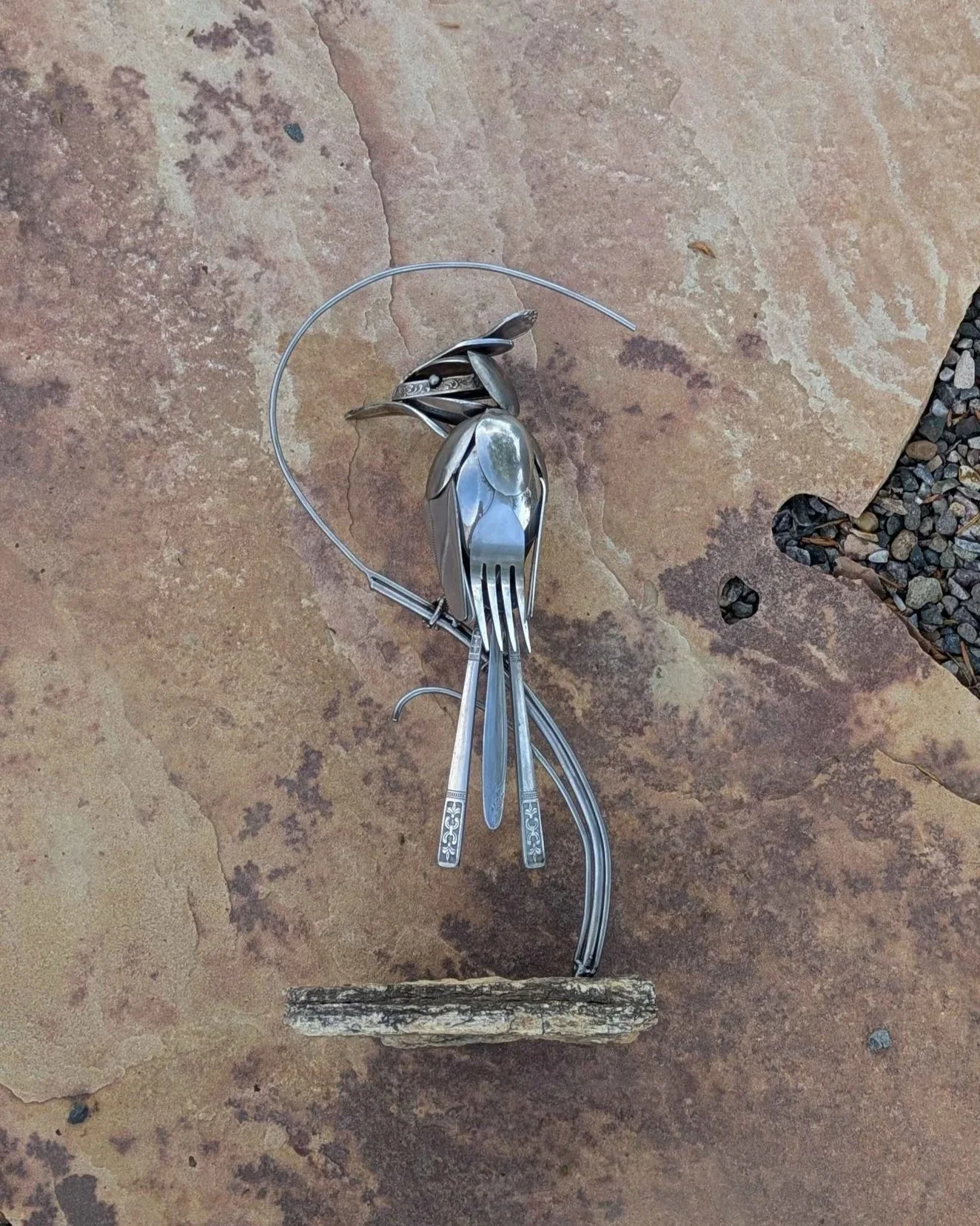 de from silverware attached to a petrified wood base.