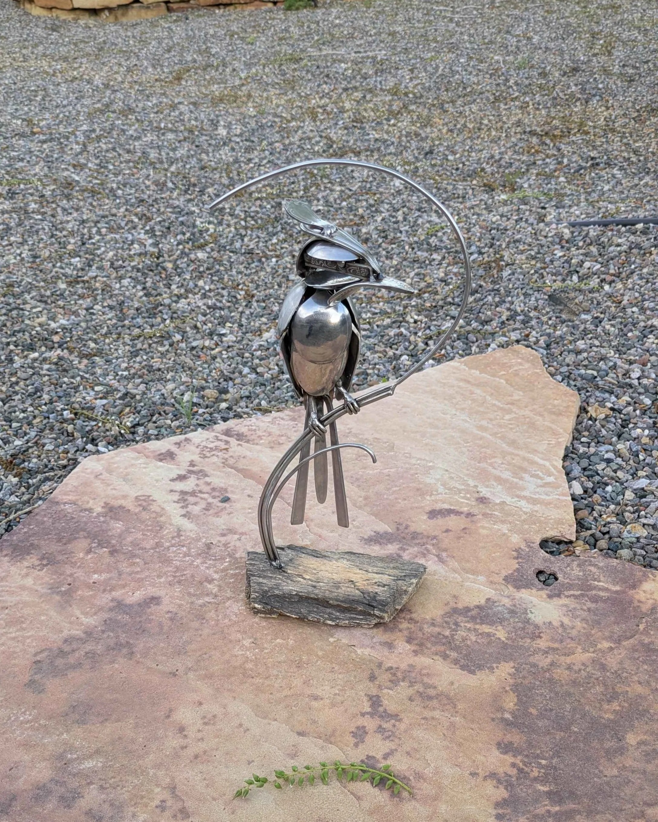 de from silverware attached to a petrified wood base.