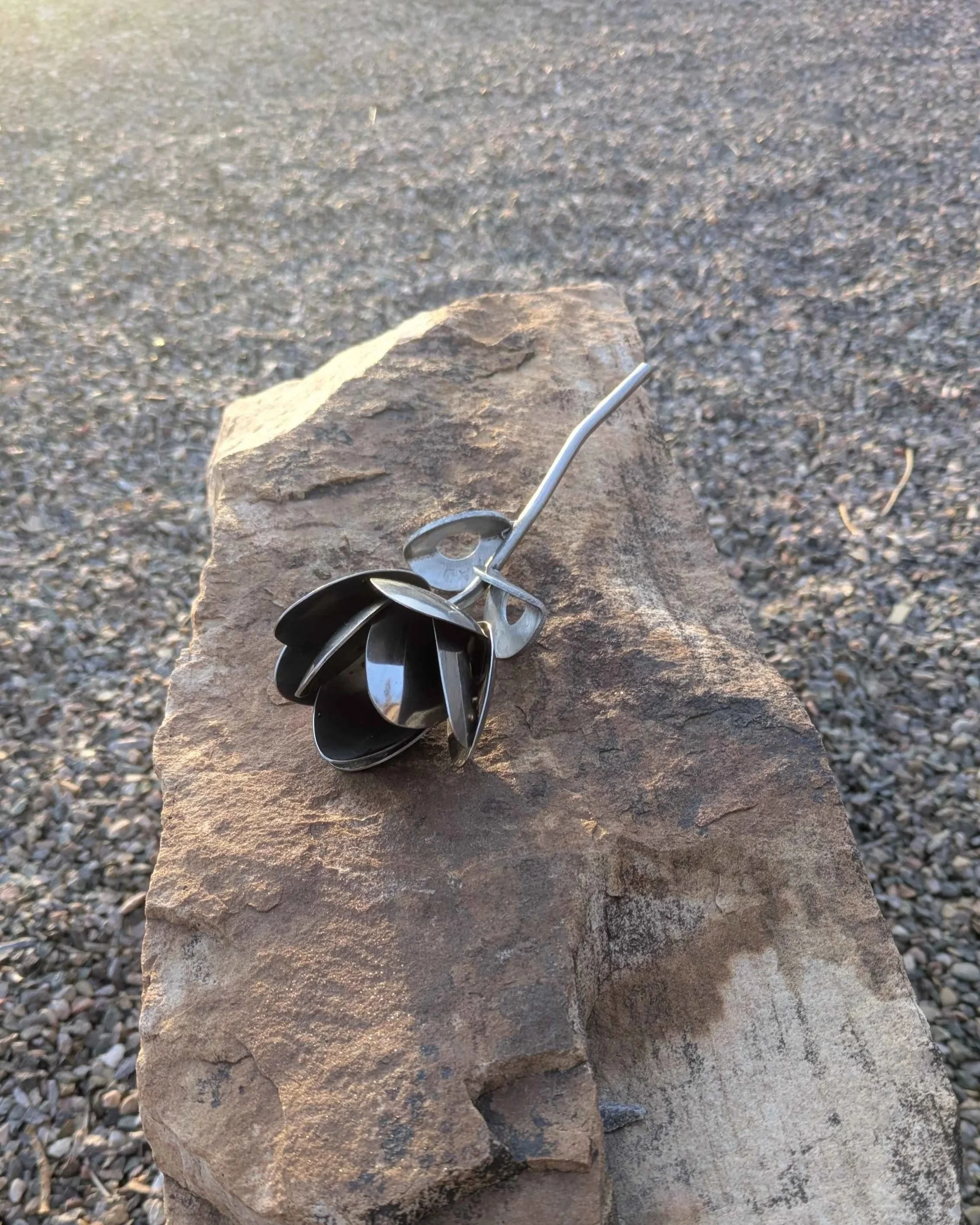 A  handmade metal art flower made from silverware, great for home decoration or as a special gift.
