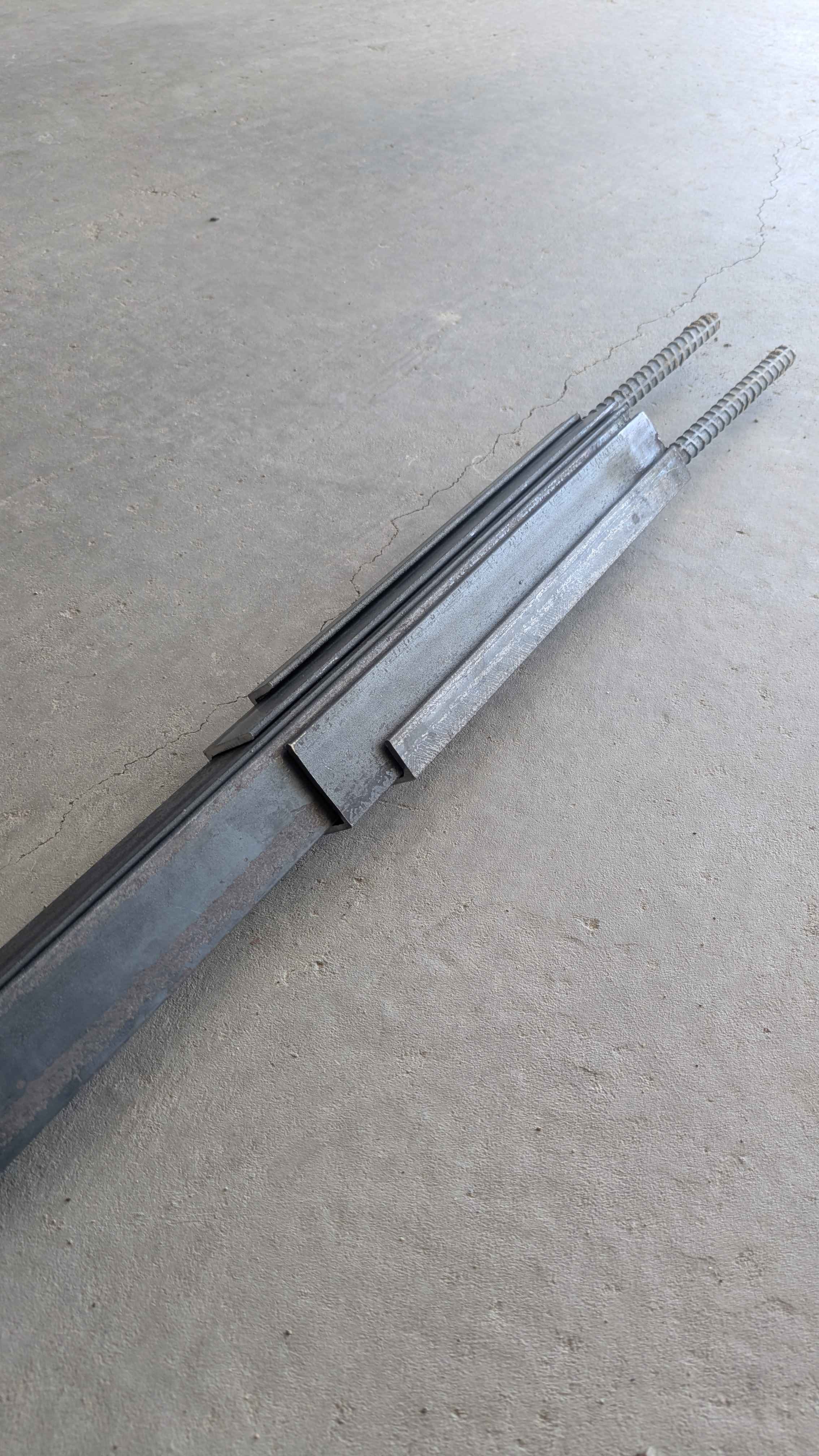 A large metal art cross sculpture made from carefully layered angle iron, designed to be a yard decoration.