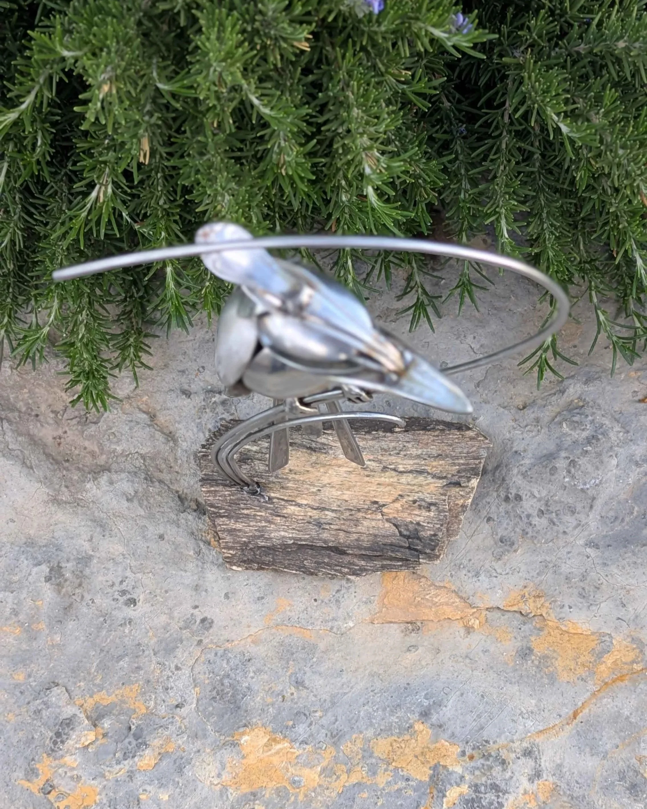 de from silverware attached to a petrified wood base.