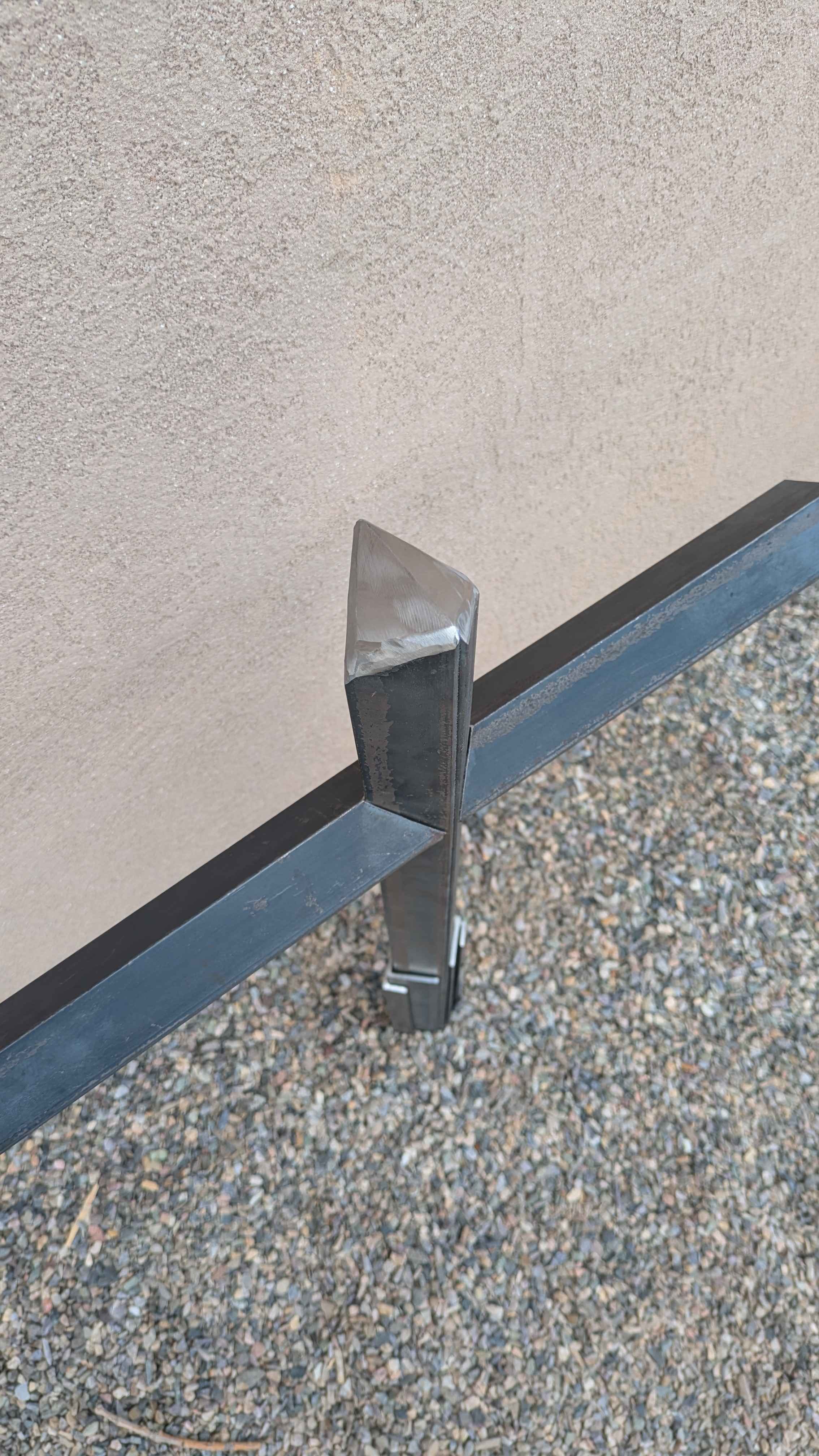 A large metal art cross sculpture made from carefully layered angle iron, designed to be a yard decoration.