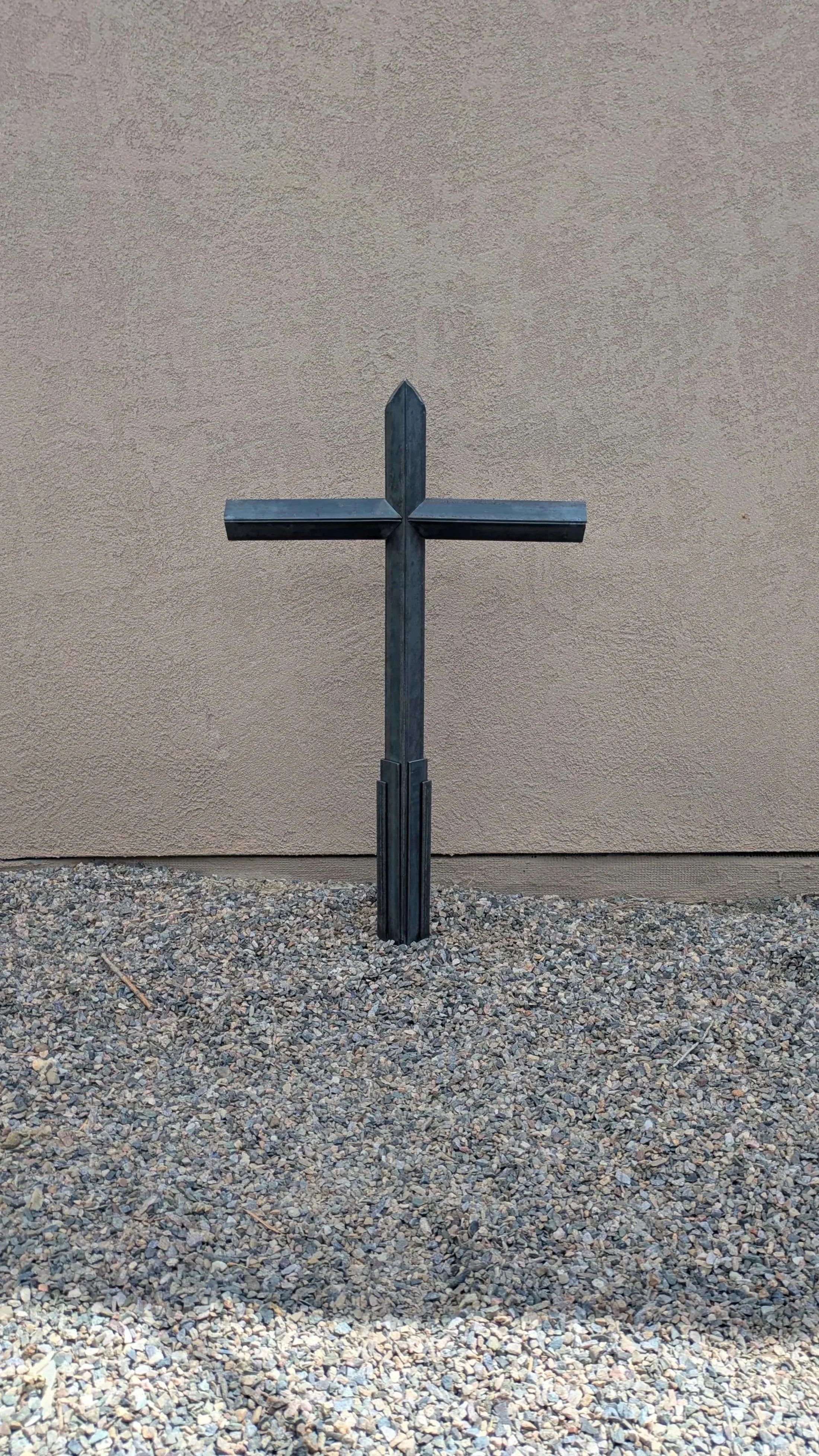 A large metal art cross sculpture made from carefully layered angle iron, designed to be a yard decoration.