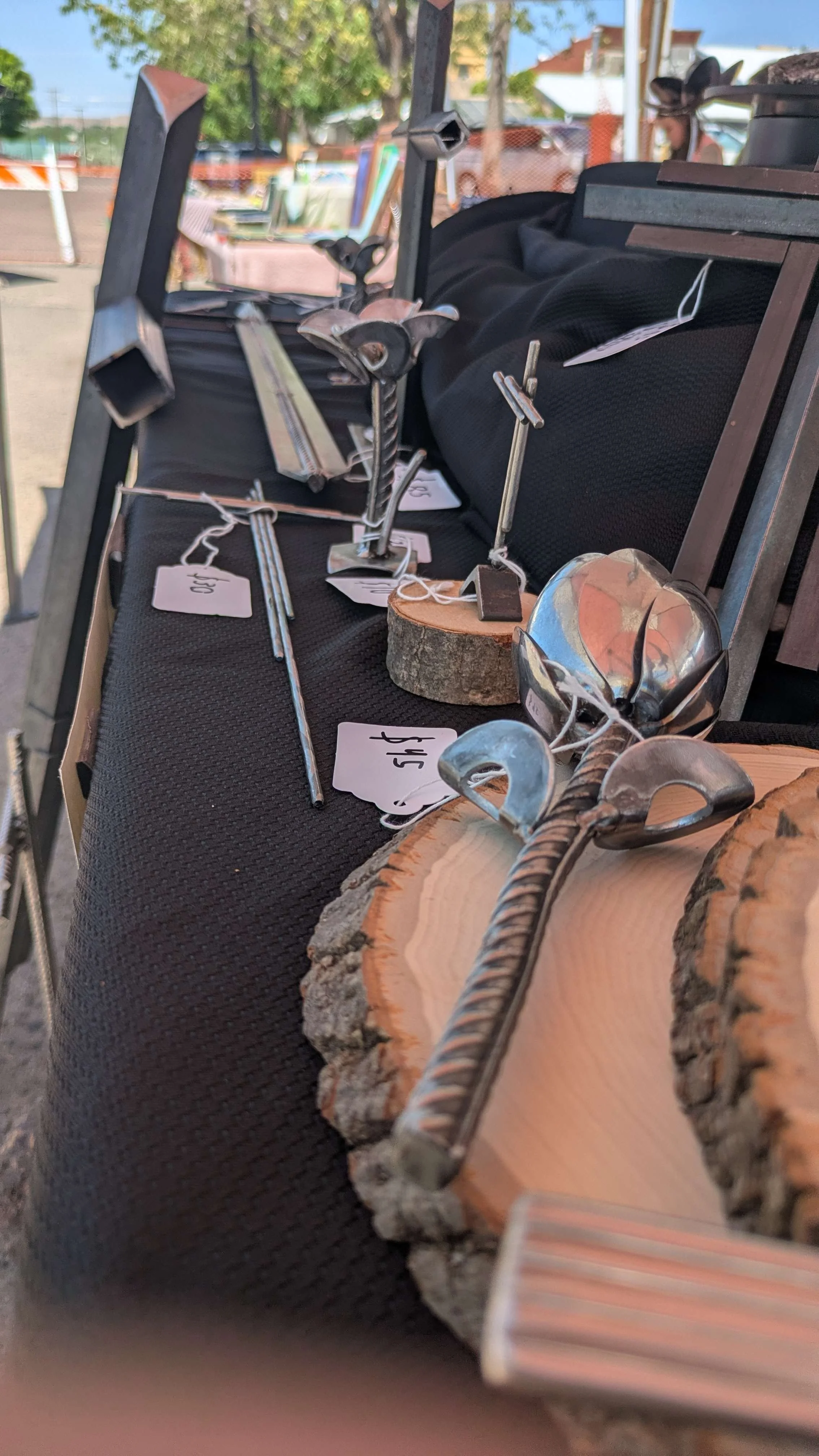 A market stall with metal art on top of it.
