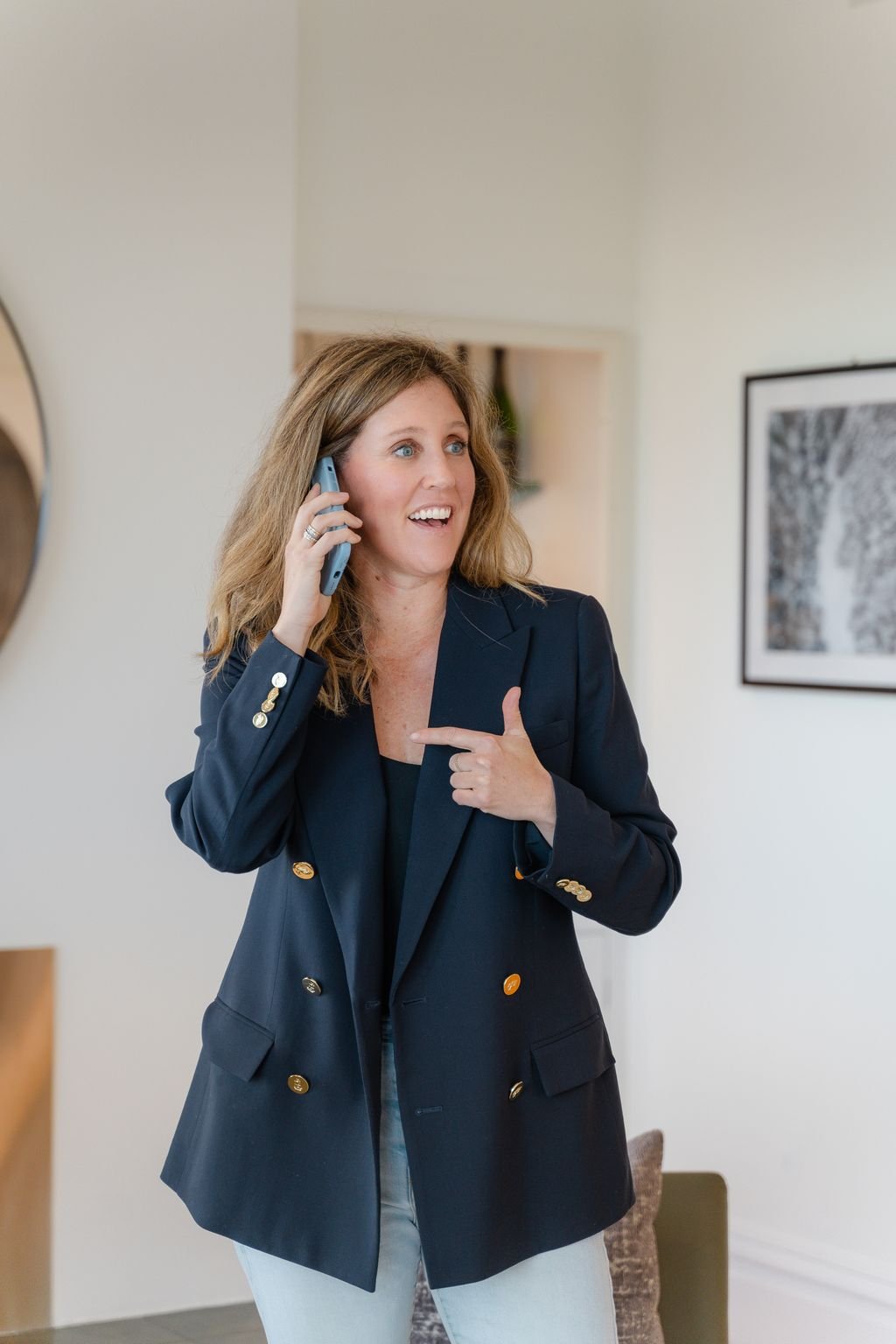 Cynthia Kellogg, a san francisco real estate agent, is talking on a phone probably negotiating a deal and smiling