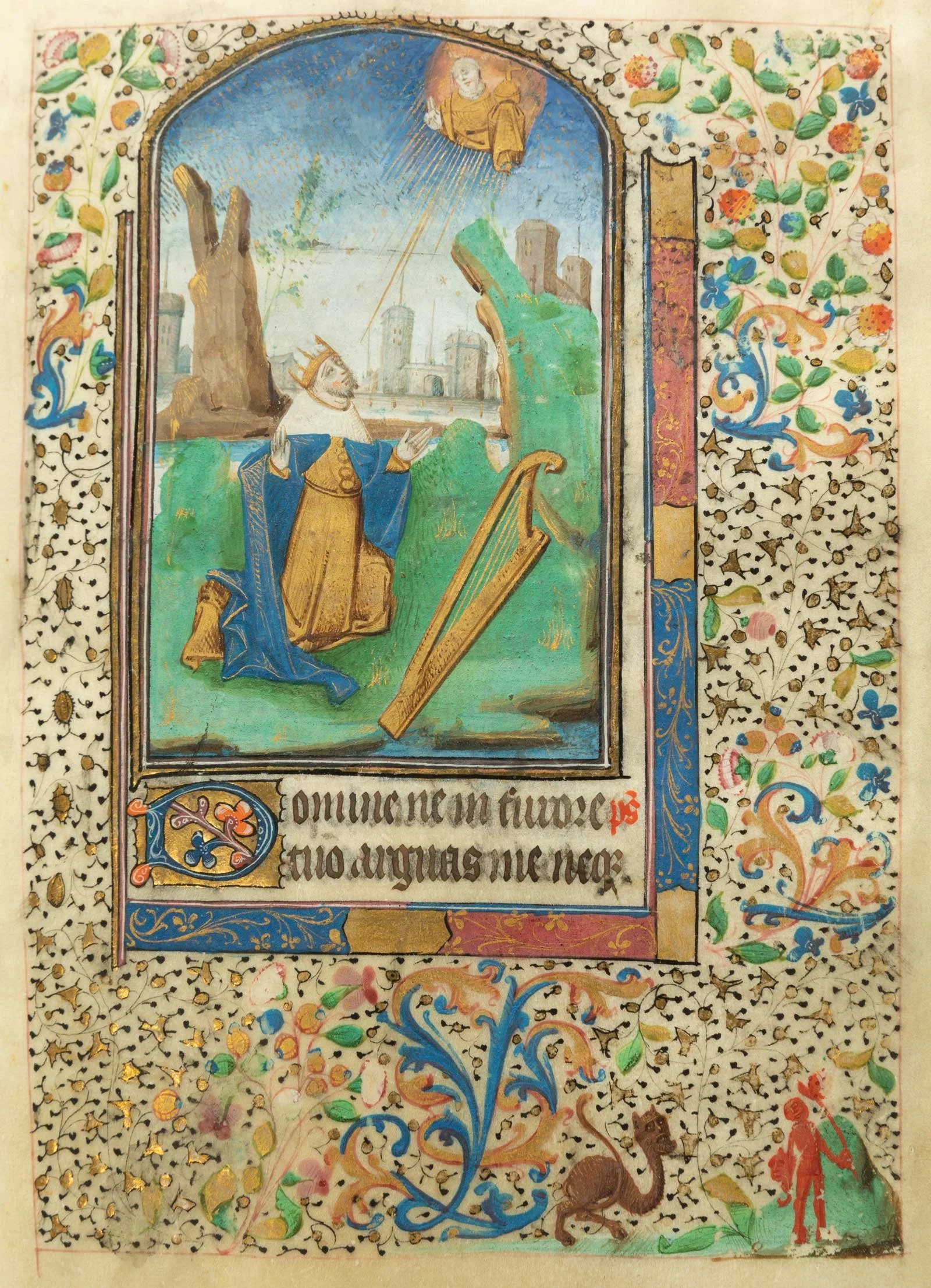 A medieval illuminated manuscript page featuring a royal figure kneeling and praying, with a castle and cityscape in the background. The scene is framed with intricate floral and gold leaf decorations, and a smaller figure in red and green stands at the bottom right corner.