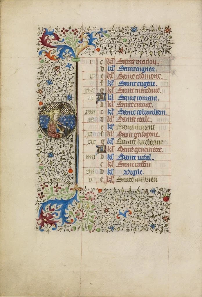 Illuminated medieval manuscript page with decorative borders, gold leaf accents, and a circular miniature of a saint playing a musical instrument. The text is in Gothic script with red and blue ink, listing saints and religious figures.