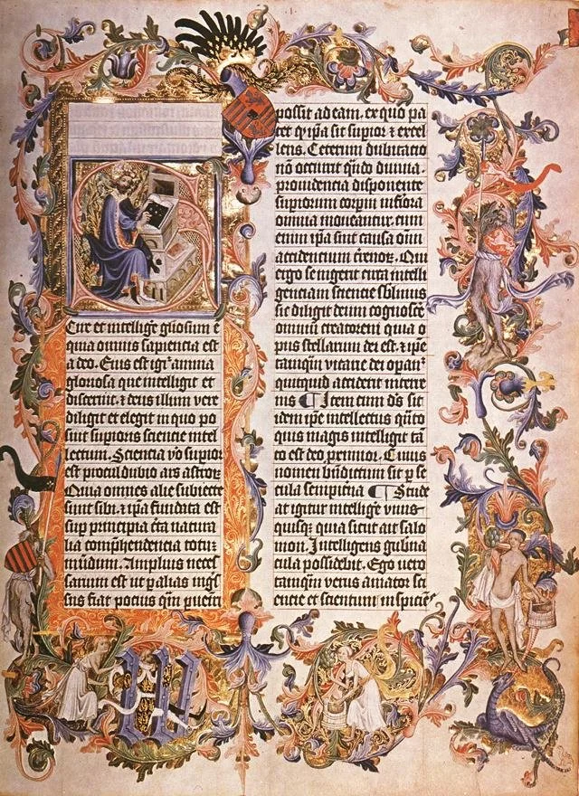 An illuminated medieval manuscript page featuring decorated borders with floral and animal motifs, a large initial letter, and a miniature image of a seated scholar or scribe reading or writing.