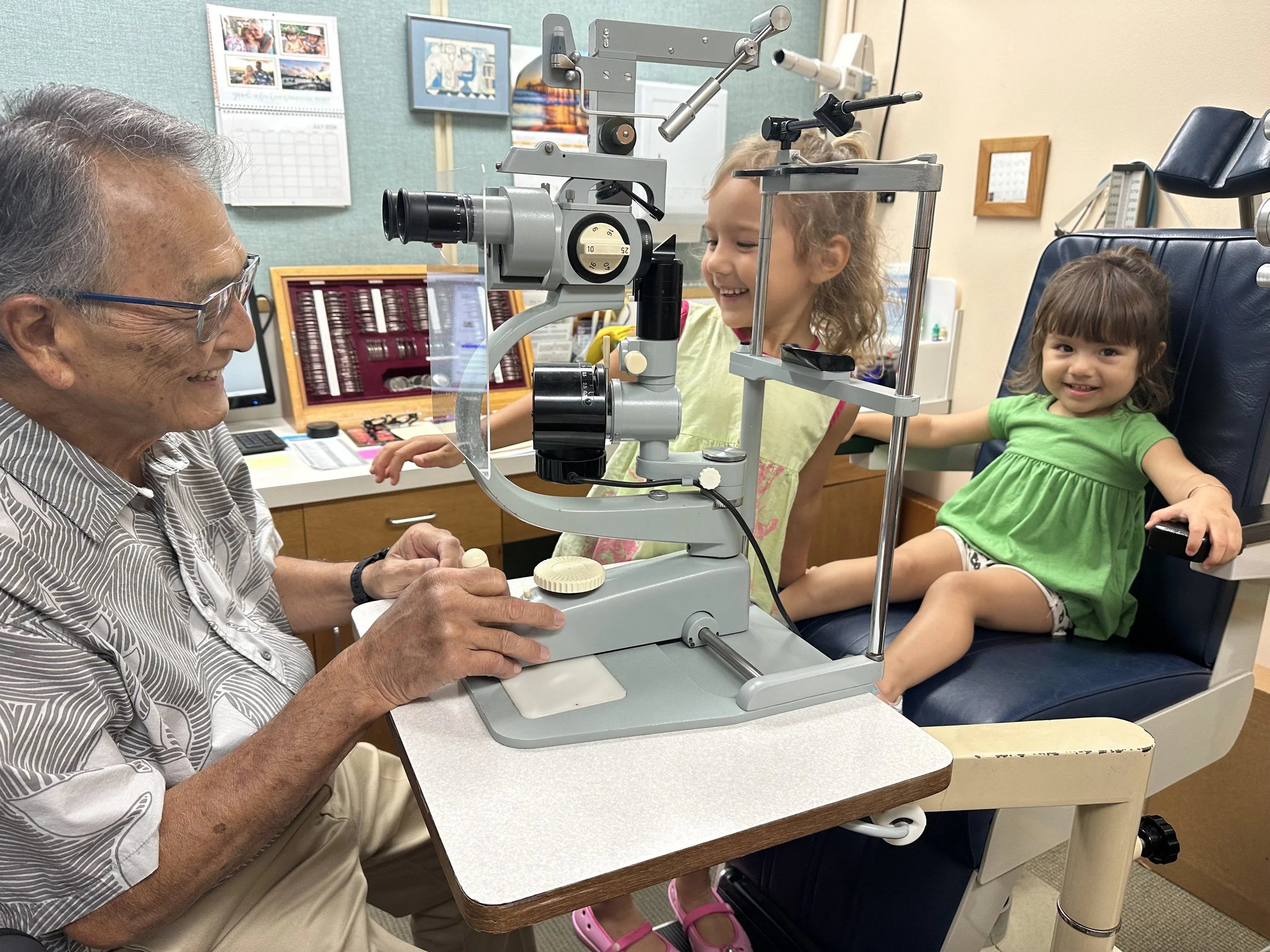Dr. Shibata performing an eye exam on his two granddaughters, for fun.