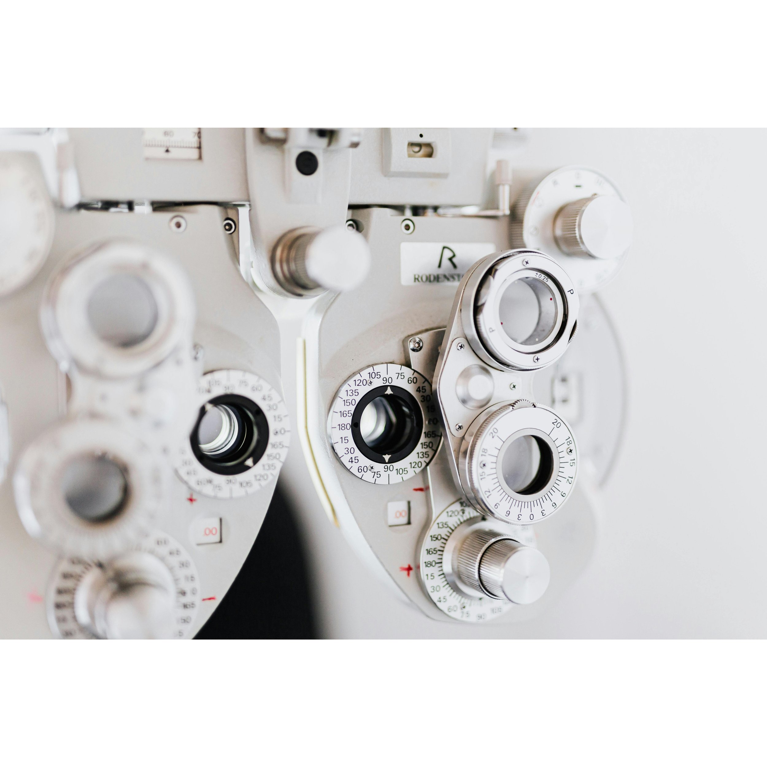 Close-up of an ophthalmic phoropter with dials and settings used for eye examinations.