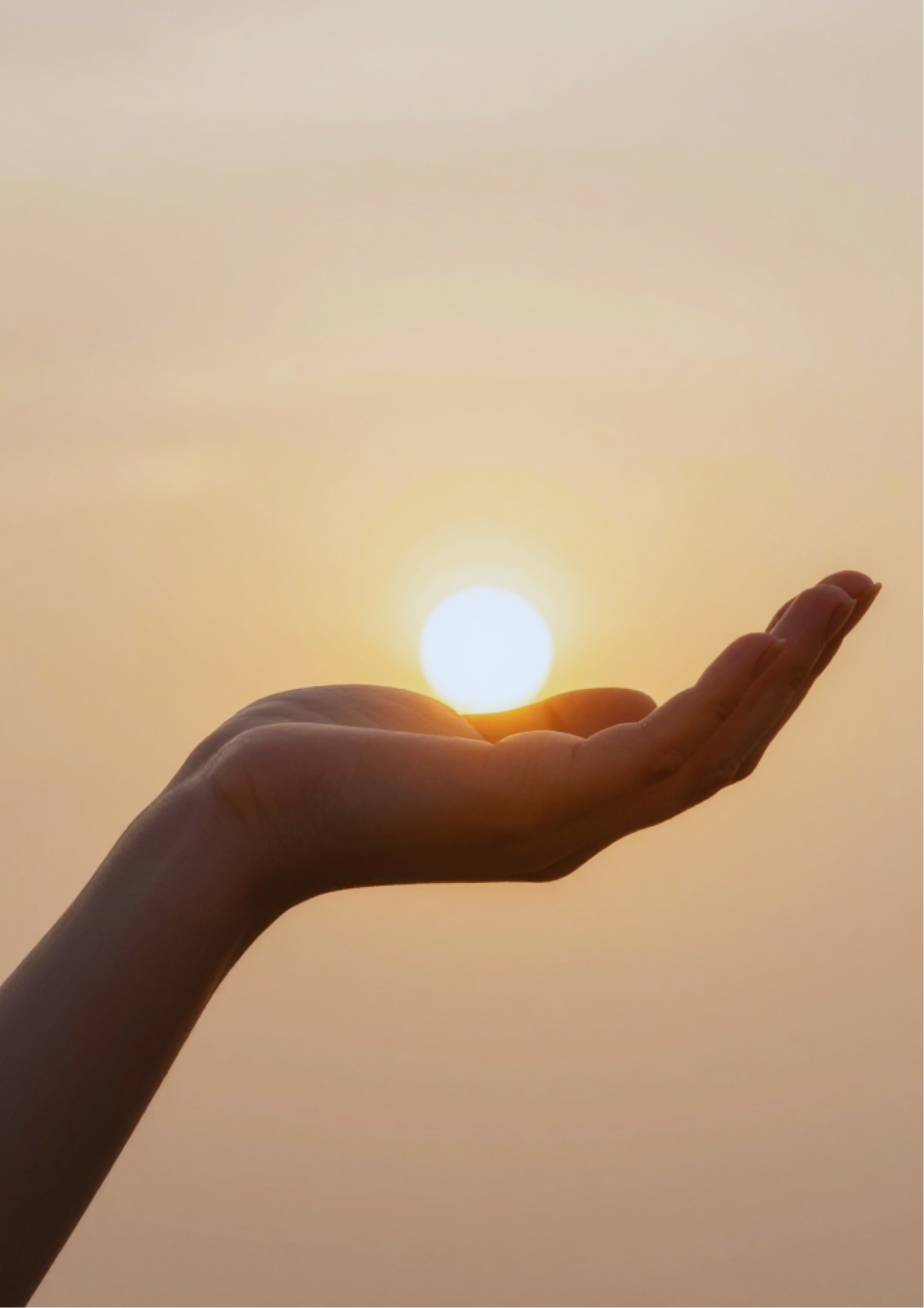 A hand holding a glowing ball of warm golden light