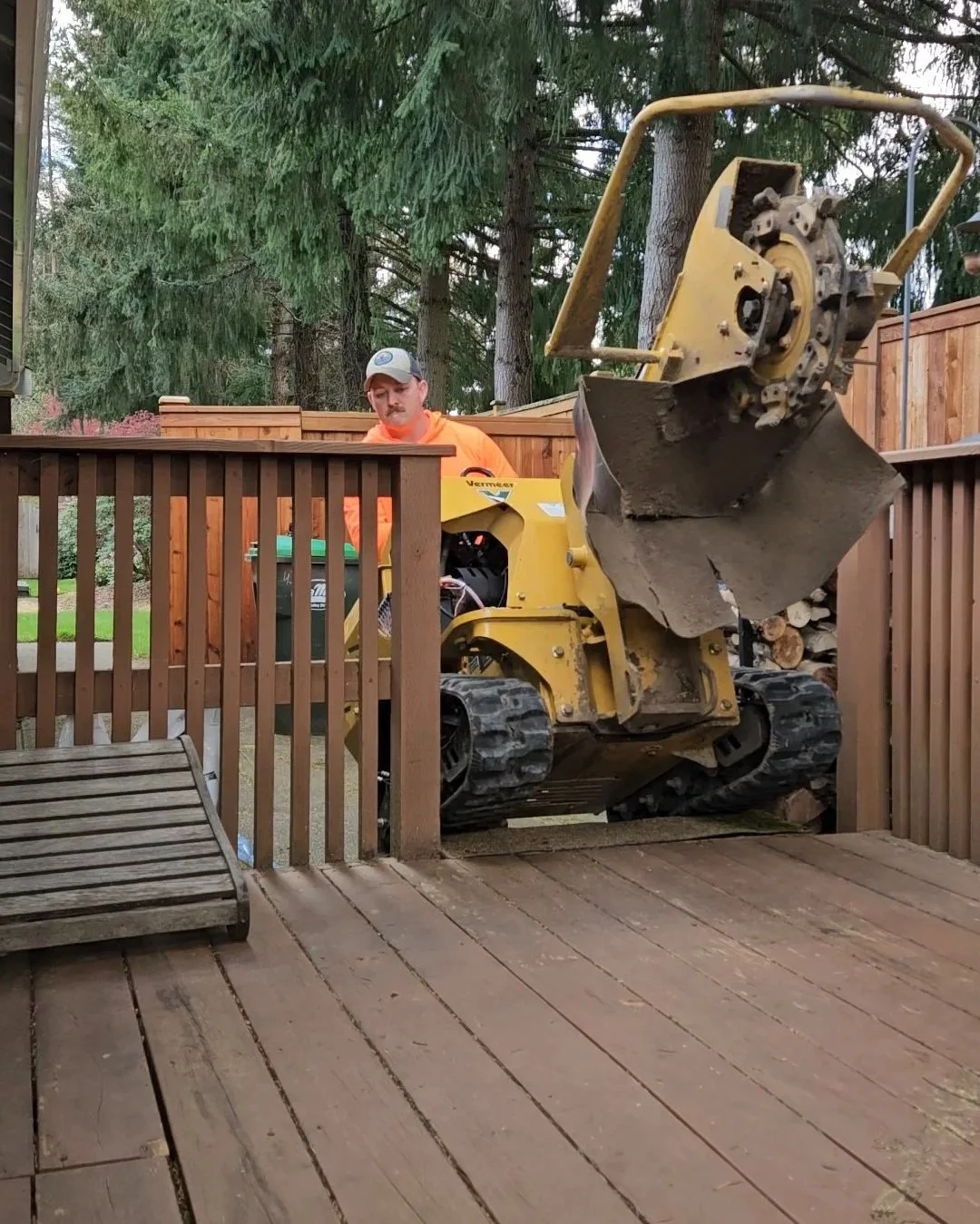 Stump grinding being driven up stairs and across a deck to for a difficult access in Olympia, WA