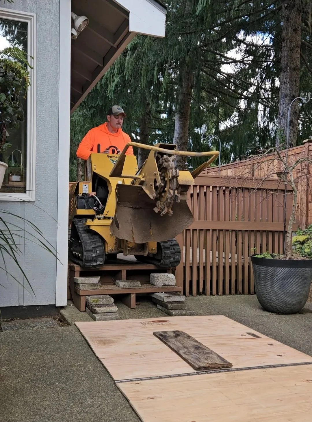 Stump grinder driving down deck steps for an extreme tight access removal other contractors denied