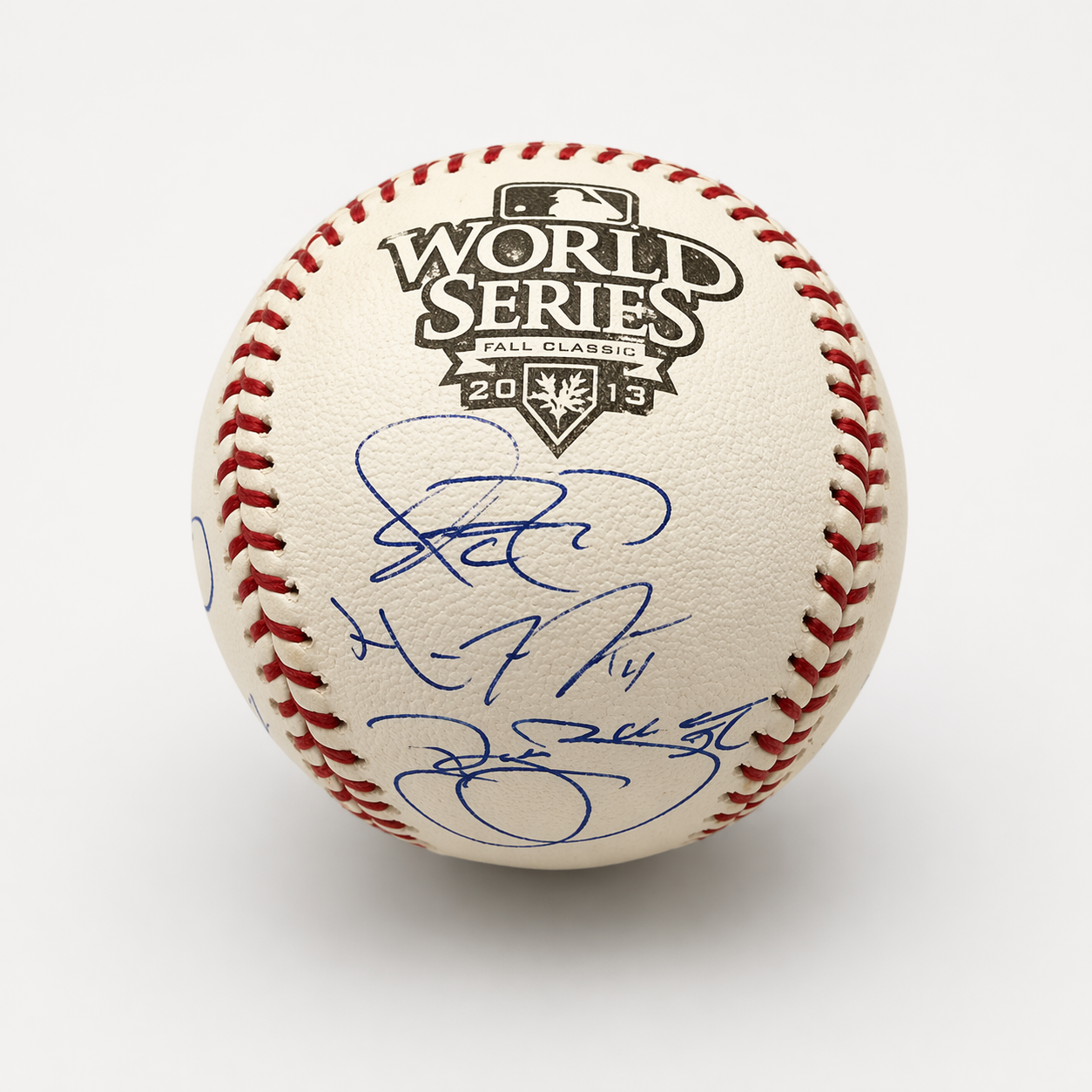 Official 2013 World Series baseball with red stitching and multiple signatures in blue ink.